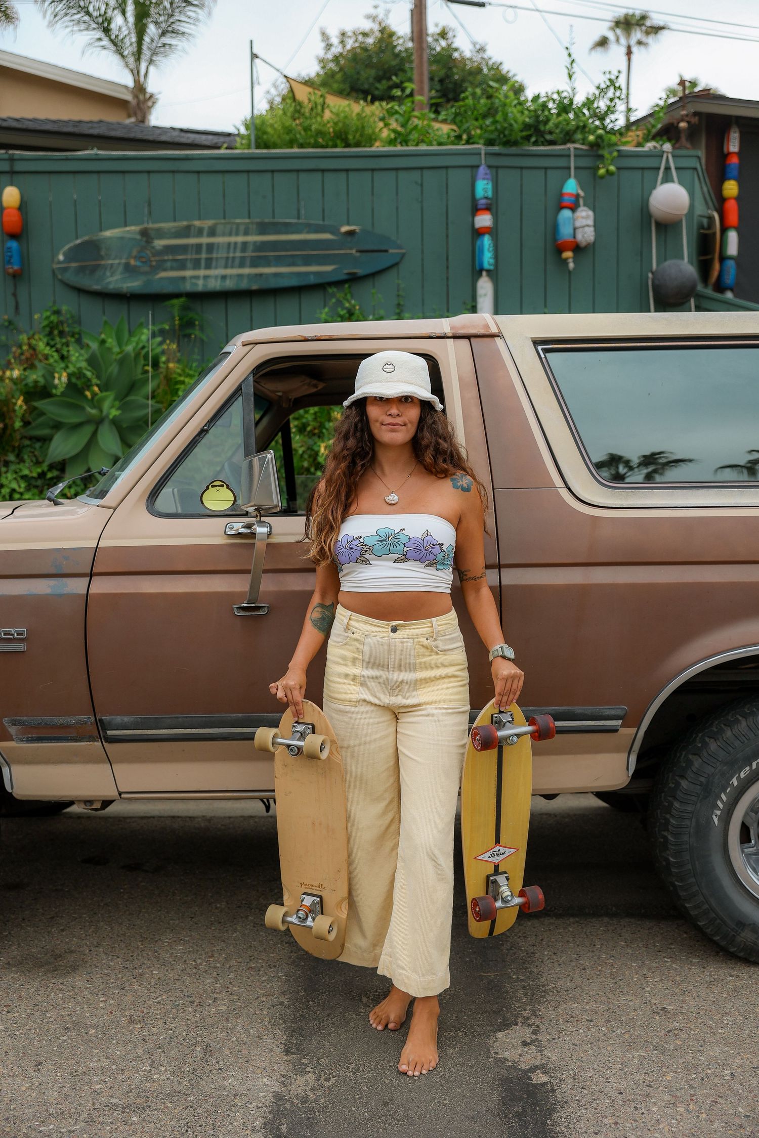 Girl wearing a yellow outfit, enjoying a sunny day while skateboarding with a carefree vibe, promoting Sunbum sunscreen.