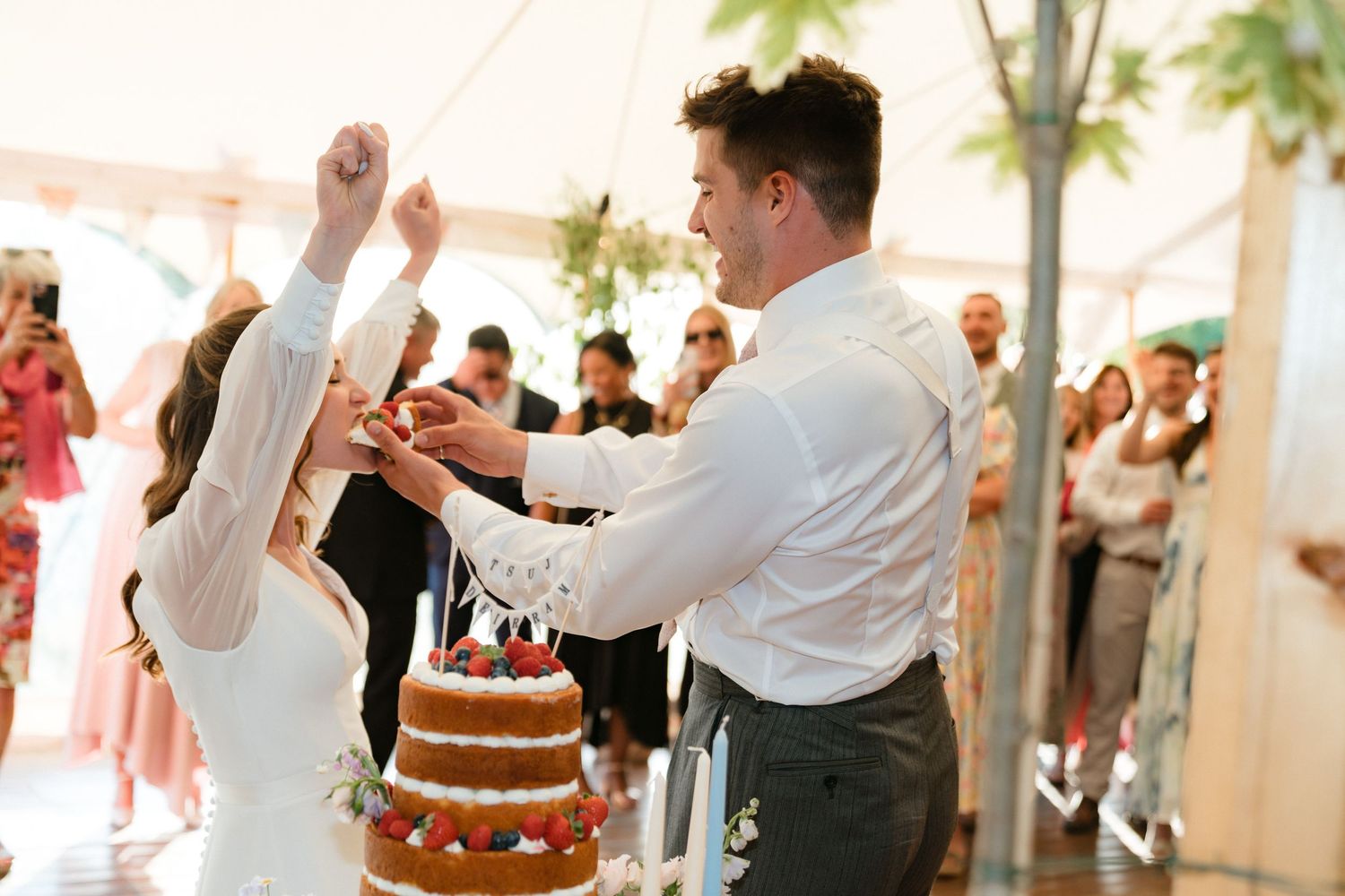 A wedding reception scene shows couples dancing together at an elegant indoor venue with palm trees visible.