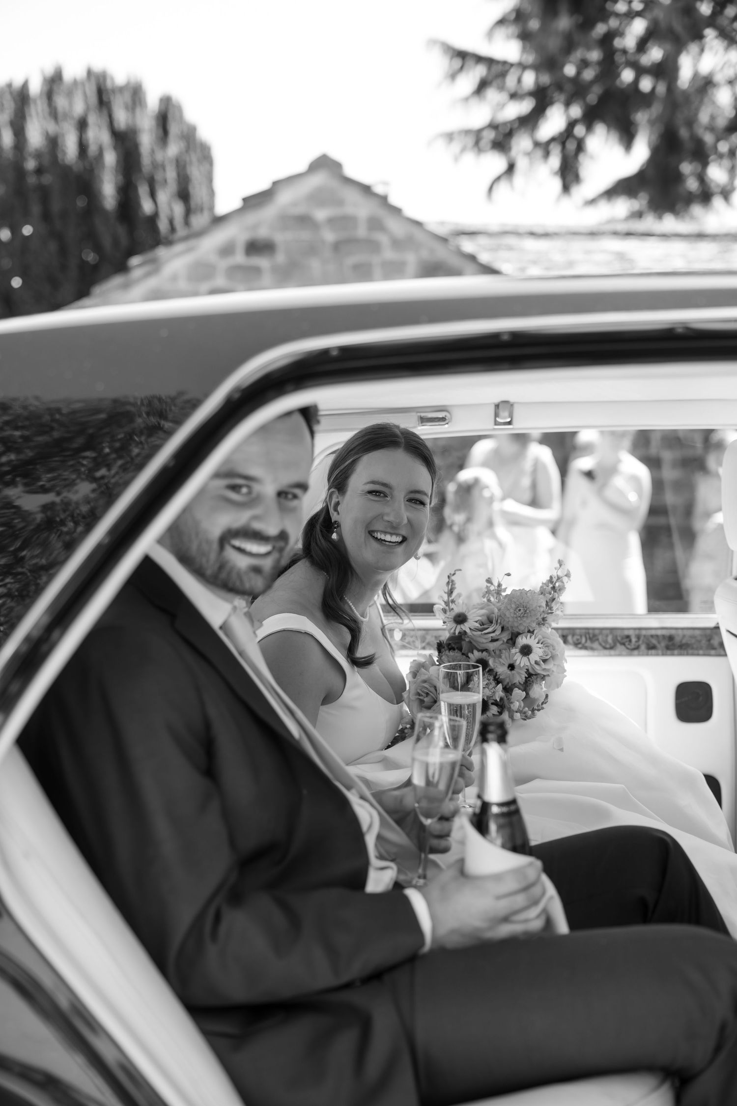 A series of black and white photos showing a couple in a wedding car sharing joyful moments together.