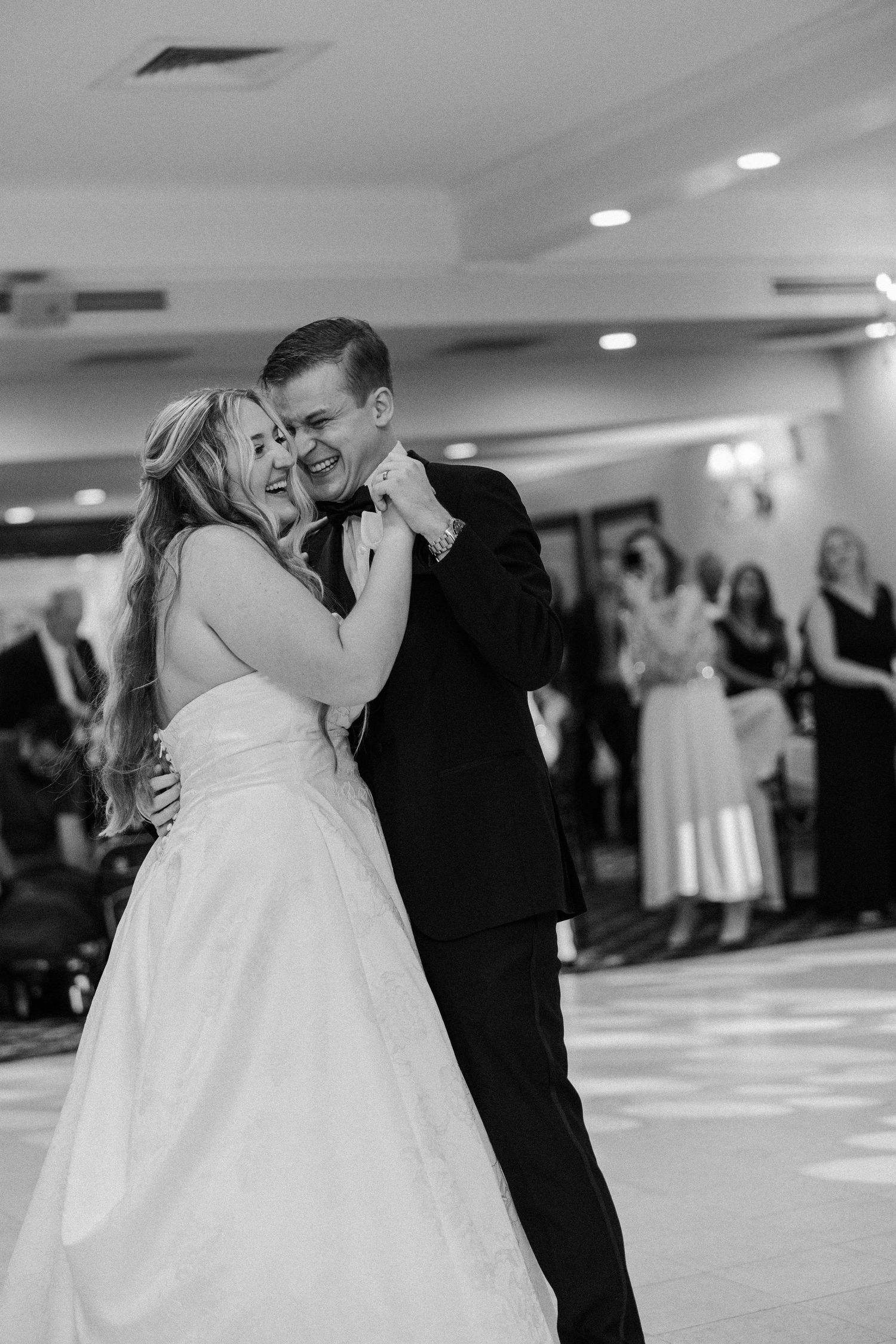Black and white photo sequence showing a romantic first dance between newlyweds at their wedding reception.