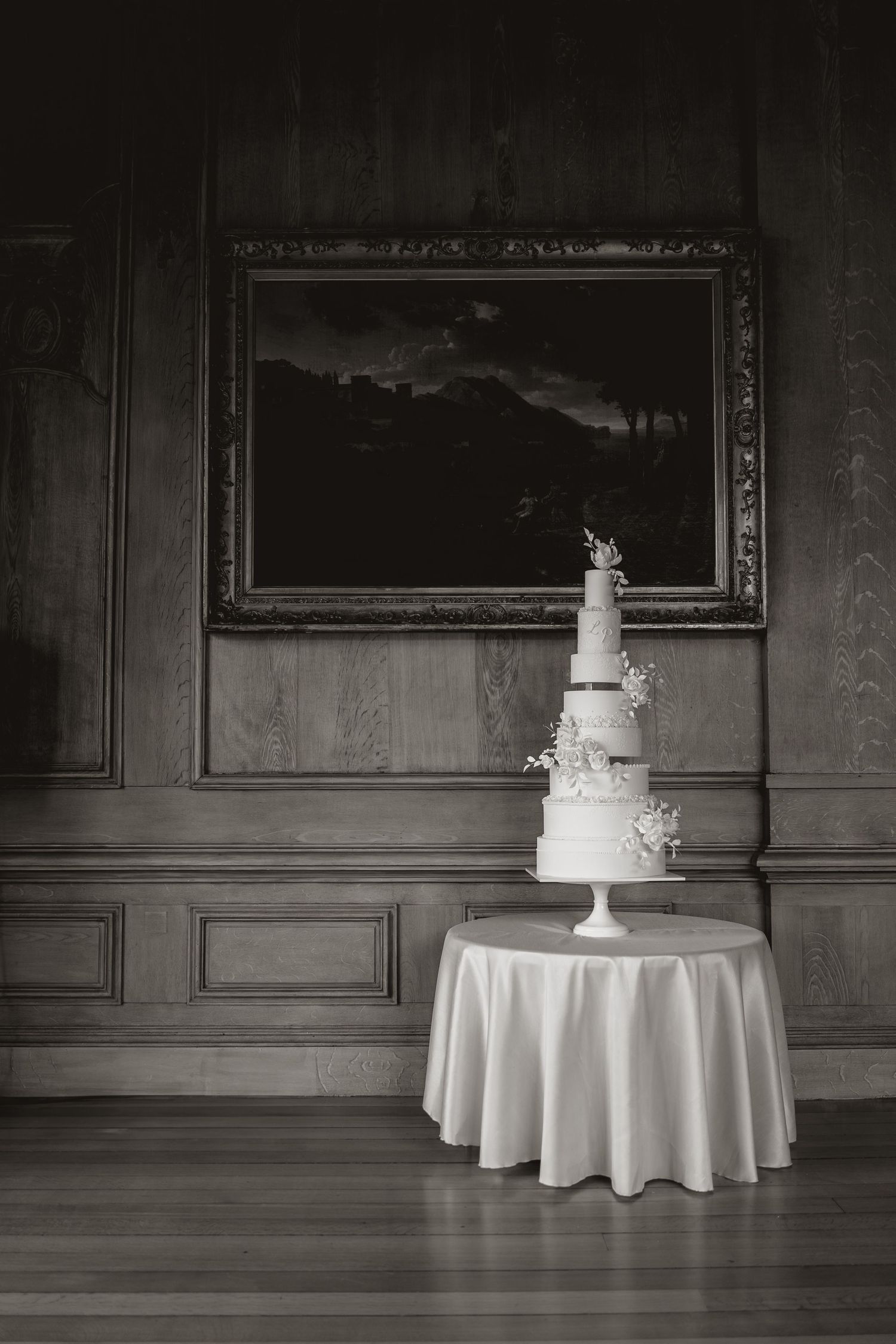 A grand elegant white wedding cake at Harlaxton Manor.