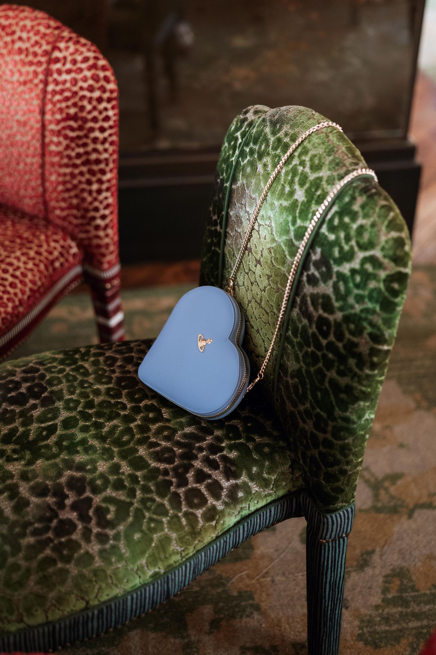 A series of macro shots showing a blue heart sticker being placed on a textured green and red surface.