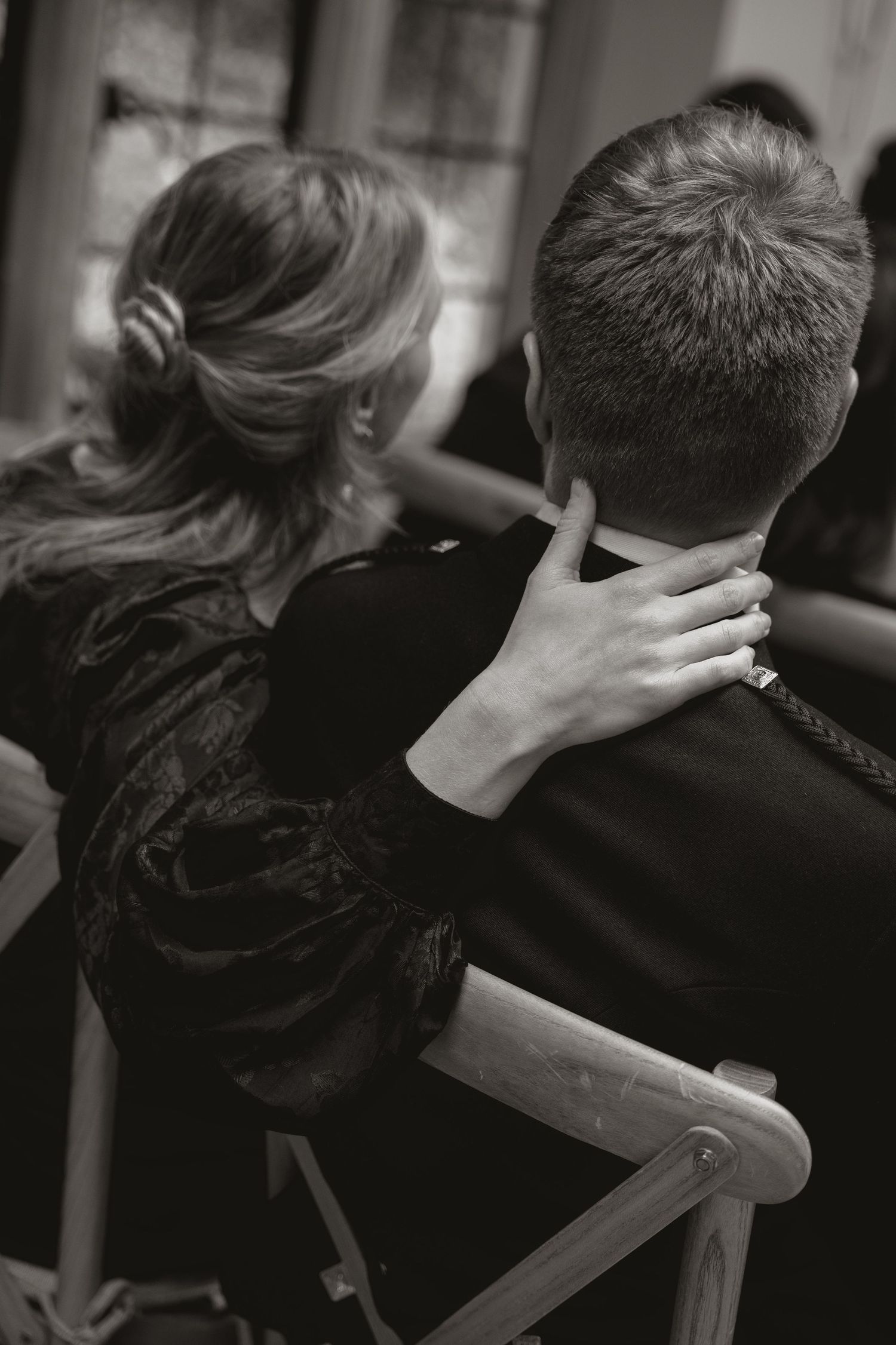 A series of black and white photographs showing someone getting a professional haircut at a salon.