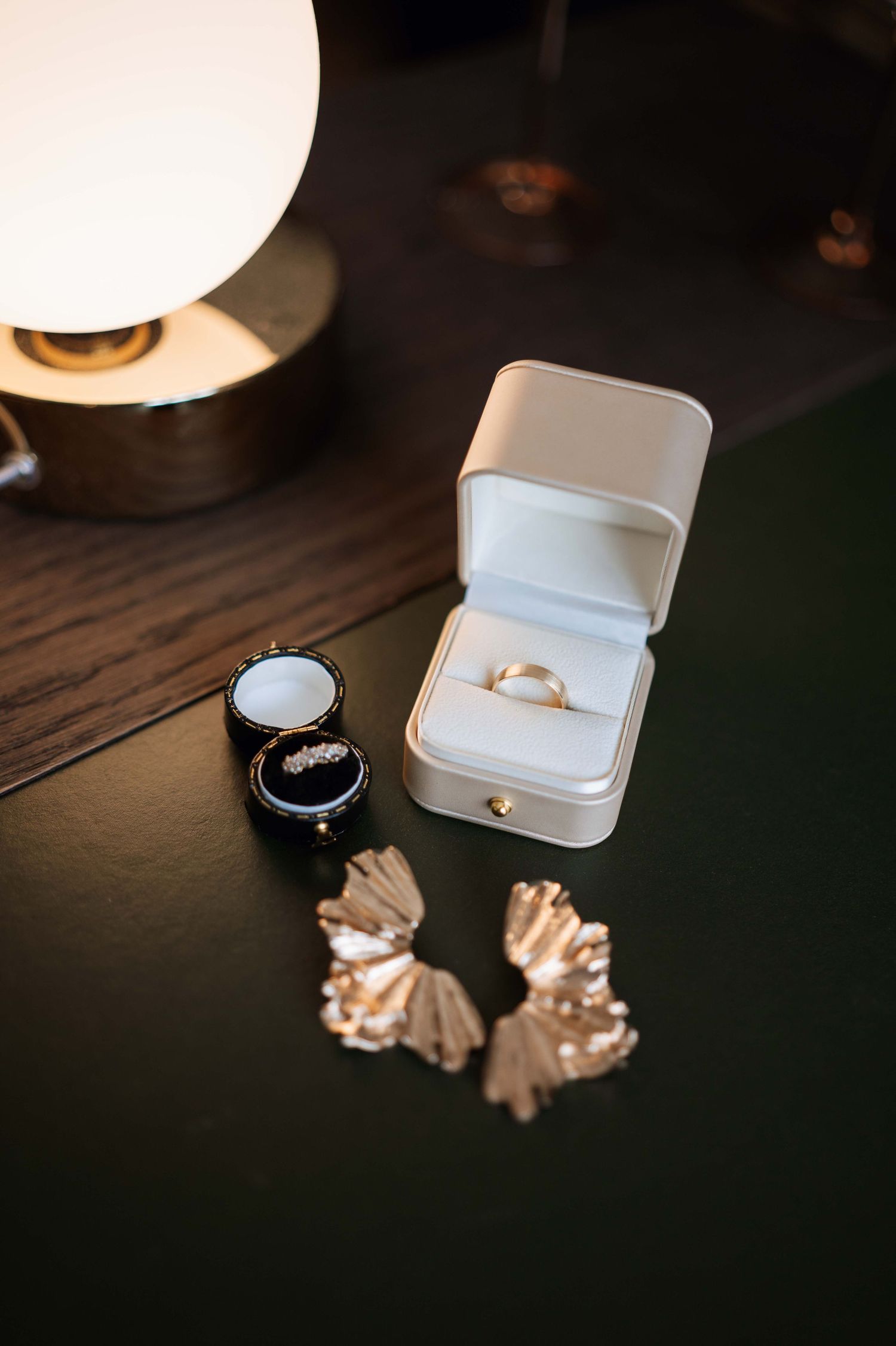 A series of wedding ring photos showing jewelry box and gold rings arranged artistically on a dark surface.