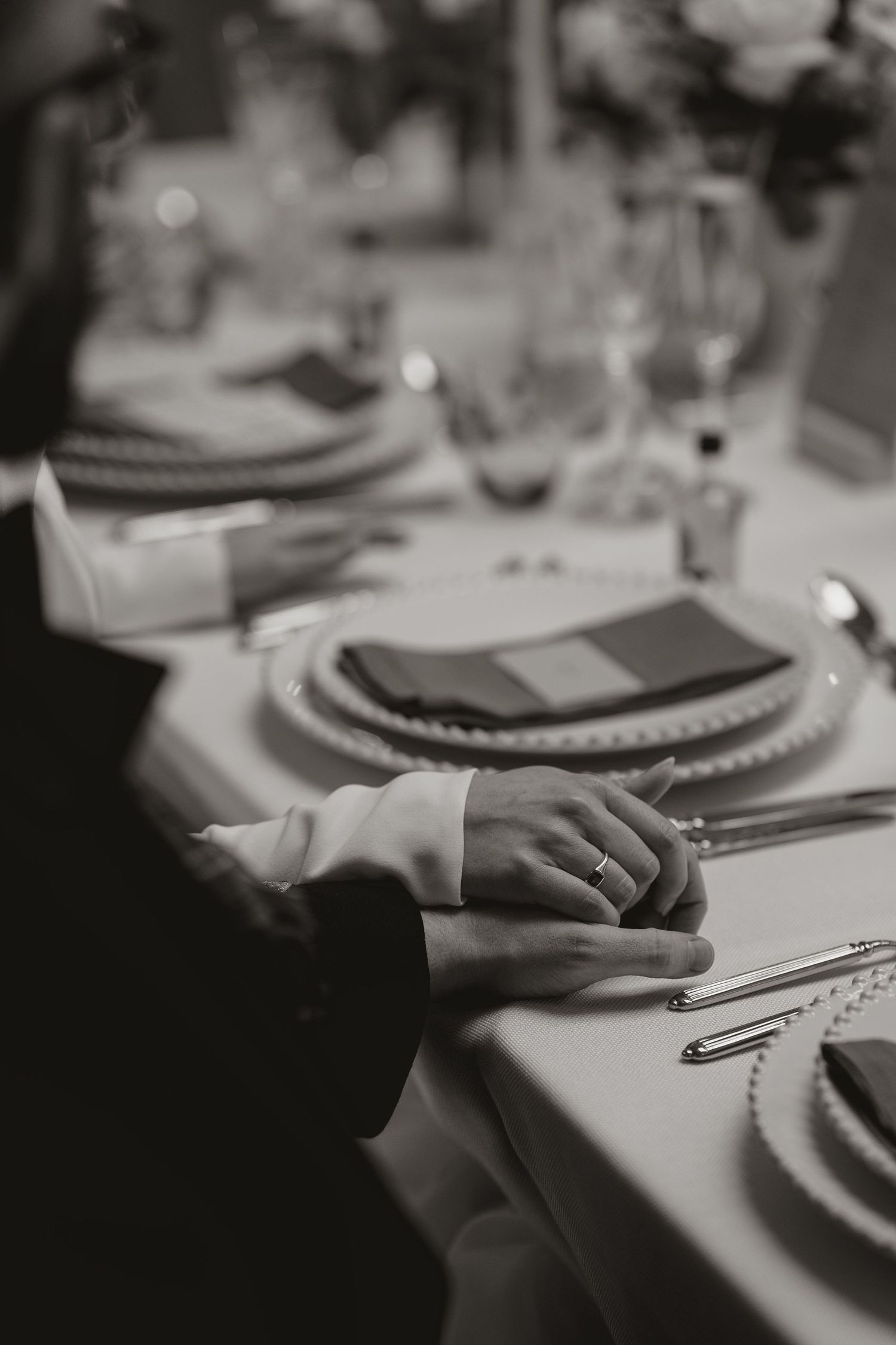 Elegant black and white table settings with place cards and fine dinnerware at a formal event.