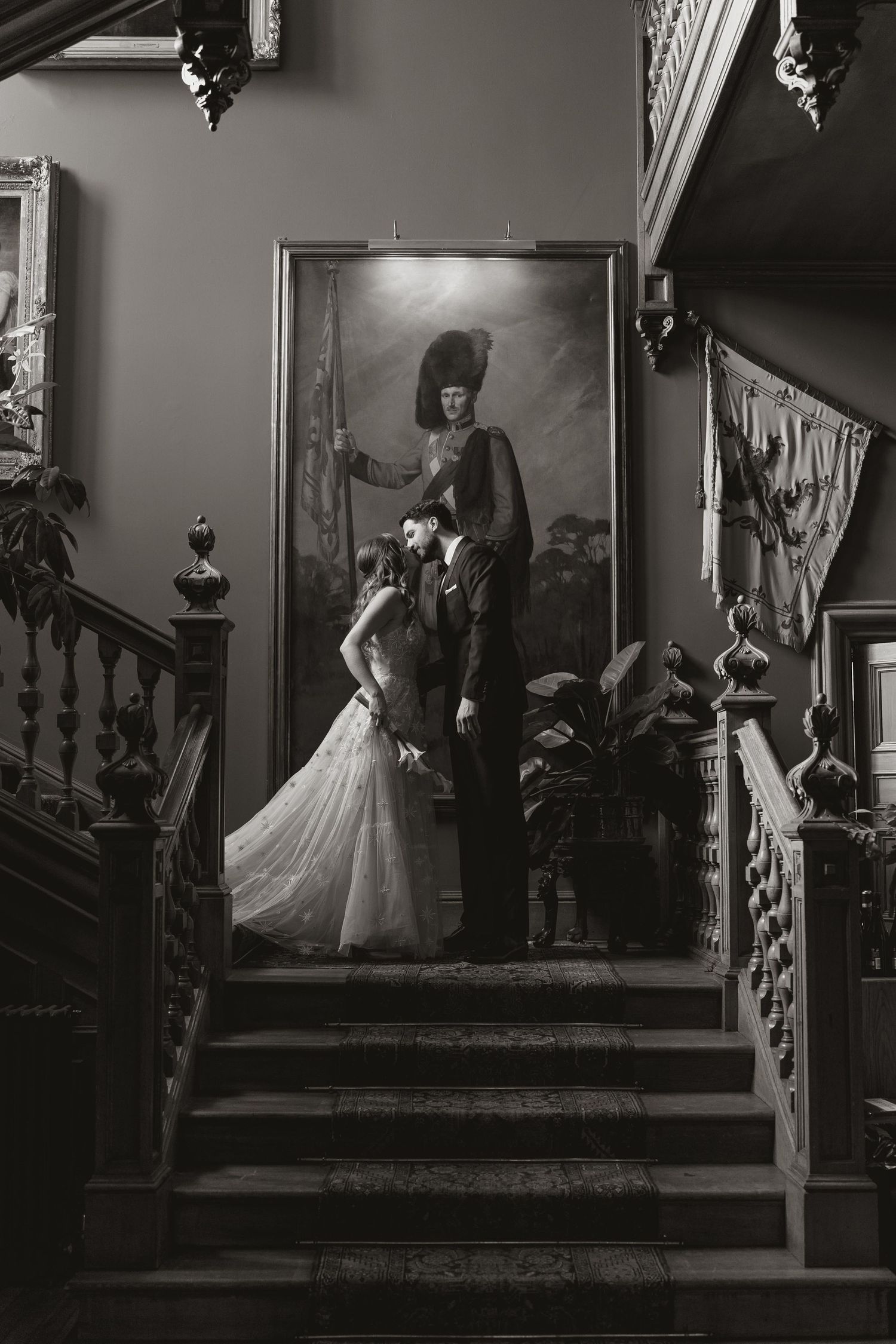A black and white photo sequence shows a woman in a flowing dress descending a grand staircase in an elegant interior.