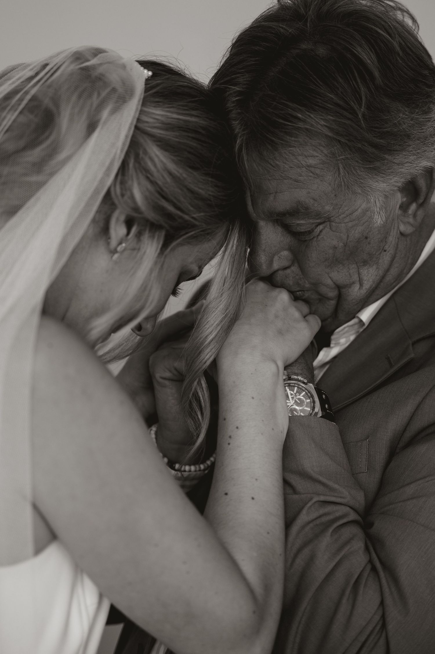 A romantic black and white photo series showing tender moments between a couple embracing and laughing together.