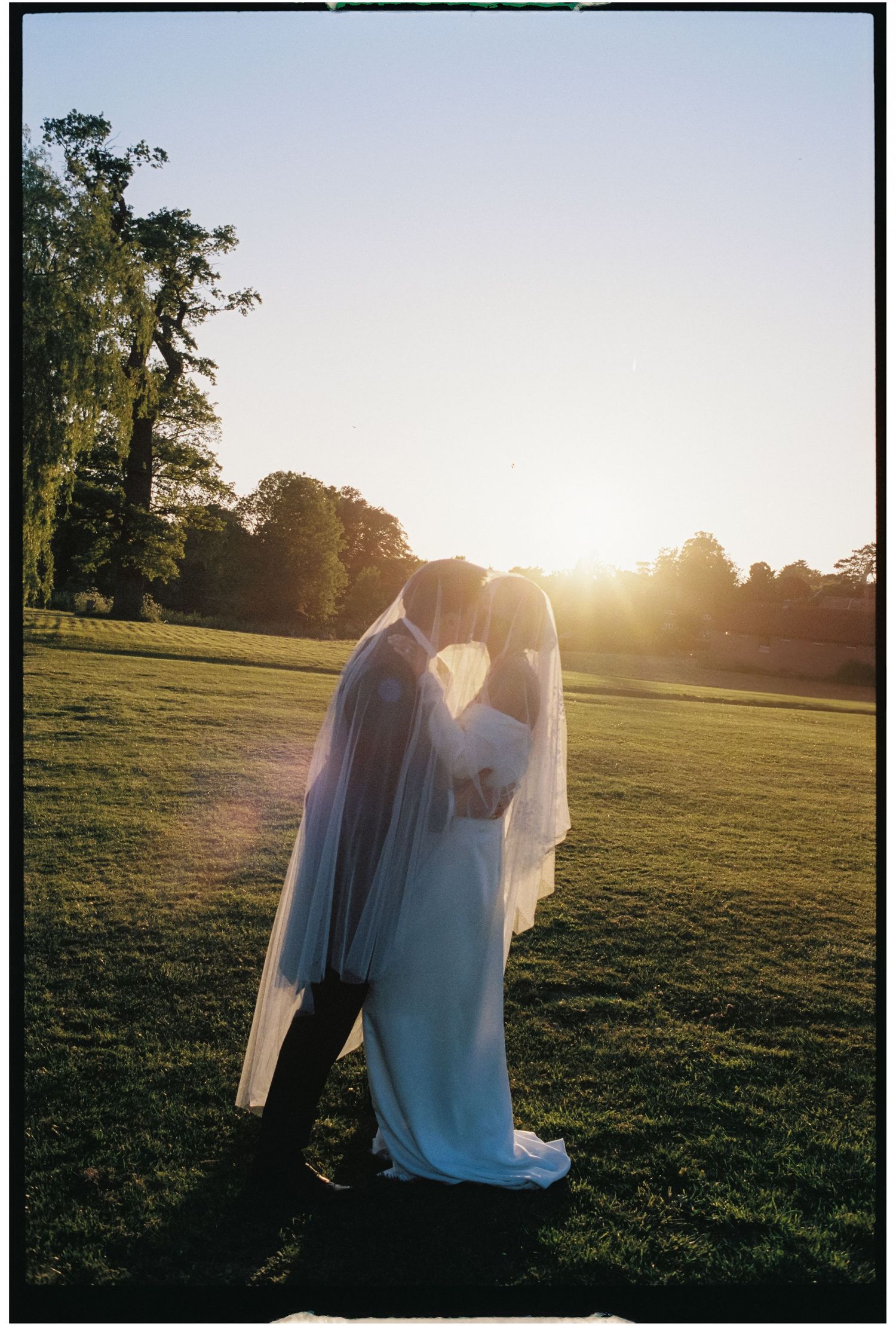 A dreamy silhouette against a golden sunset in a grassy field creates a warm, ethereal atmosphere.