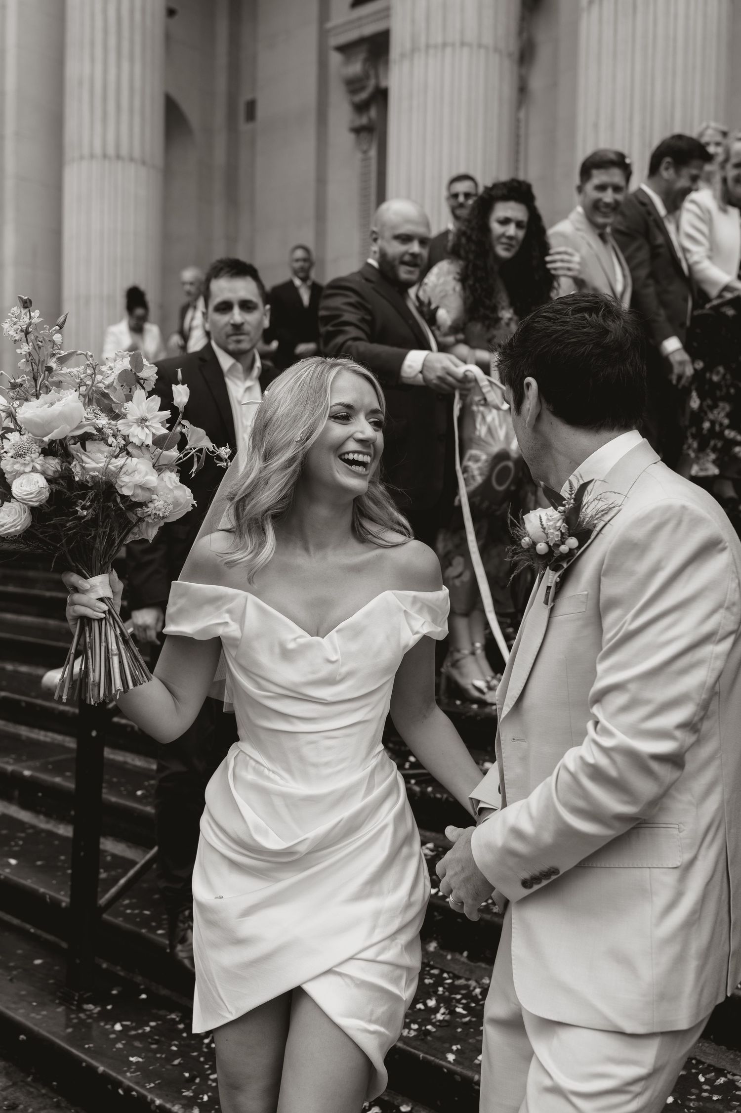 Black and white photo series showing joyful moments of a bride and groom dancing and laughing during their wedding celebration.