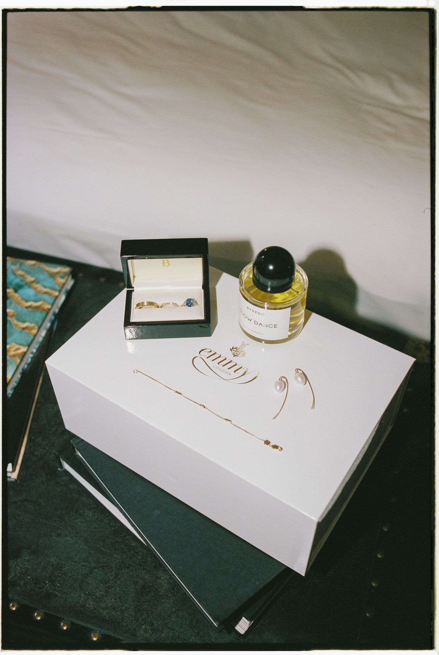 A sequence of photos showing a white box or package on a dark surface with various small objects around it.