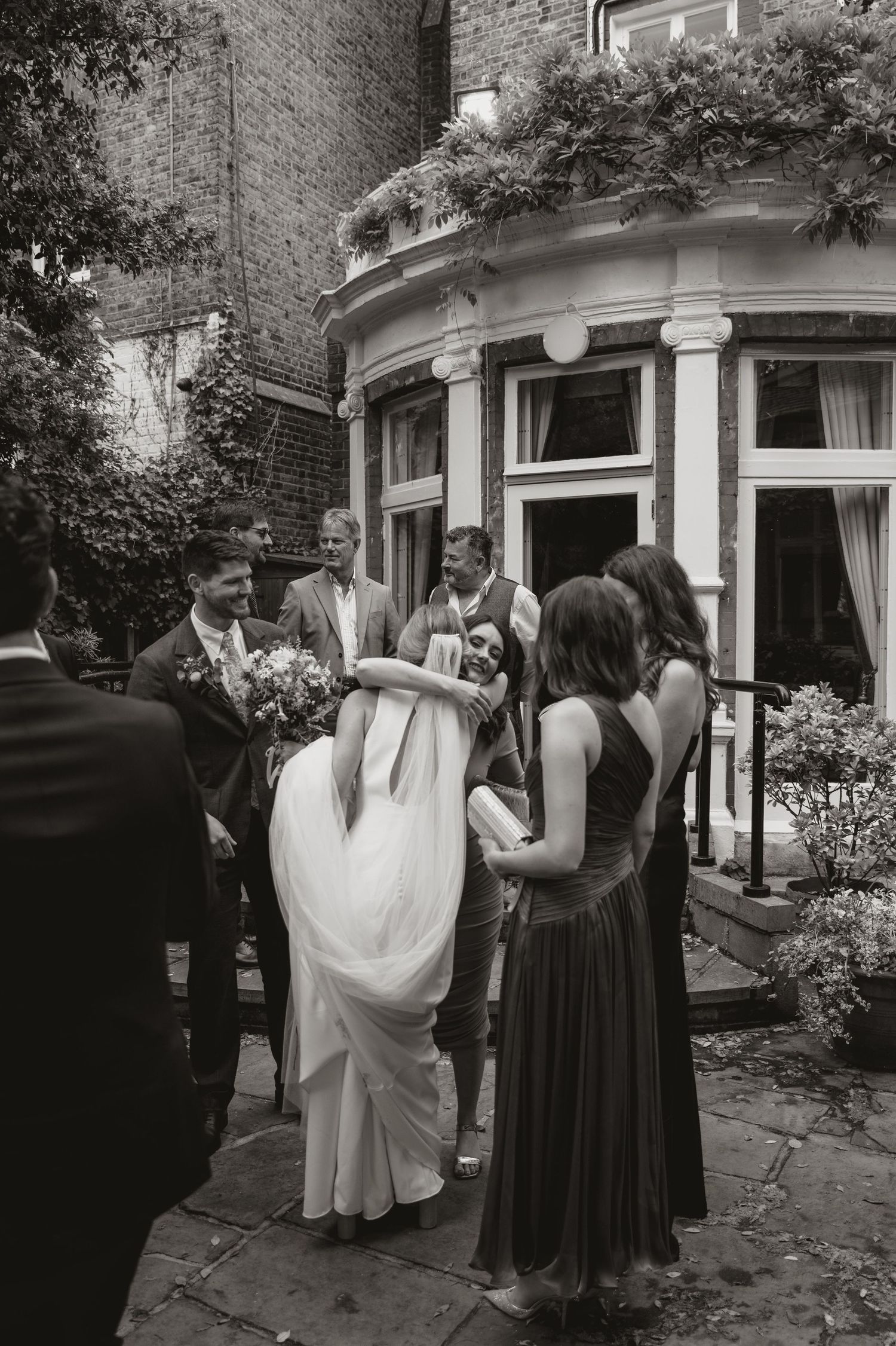A series of black and white photographs showing people gathered outside a building during a formal event.