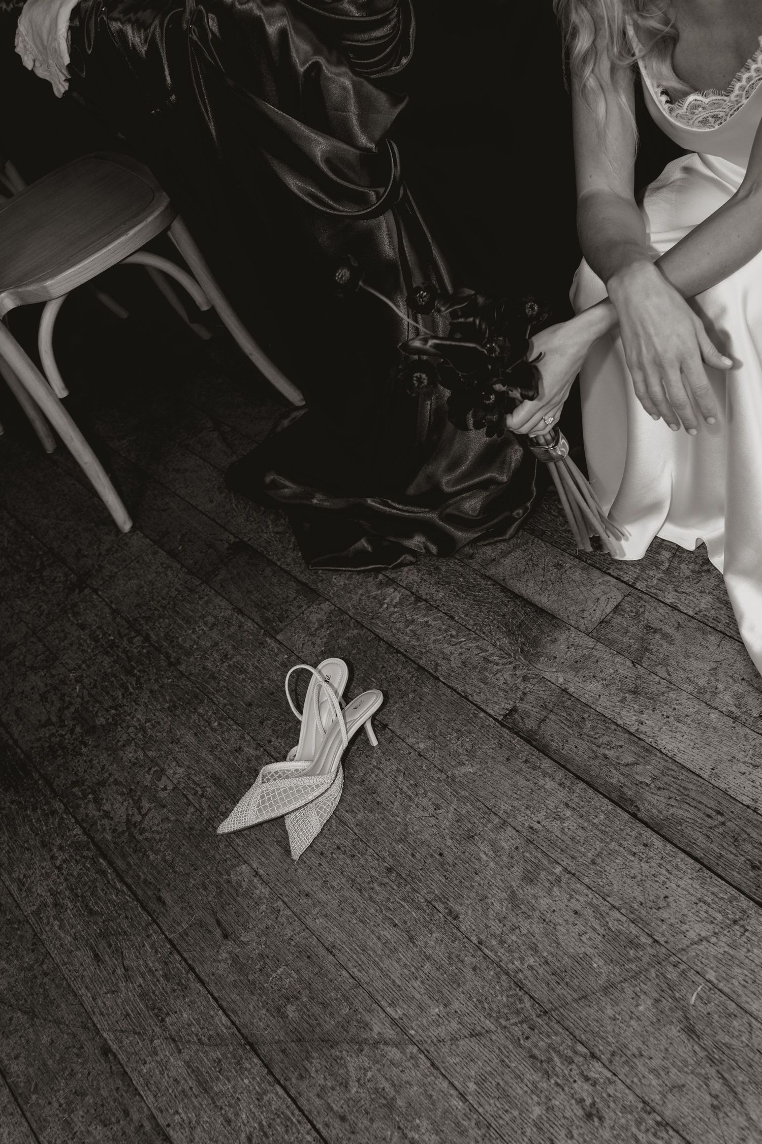 A series of black and white photos showing white high heel shoes on a wooden floor.
