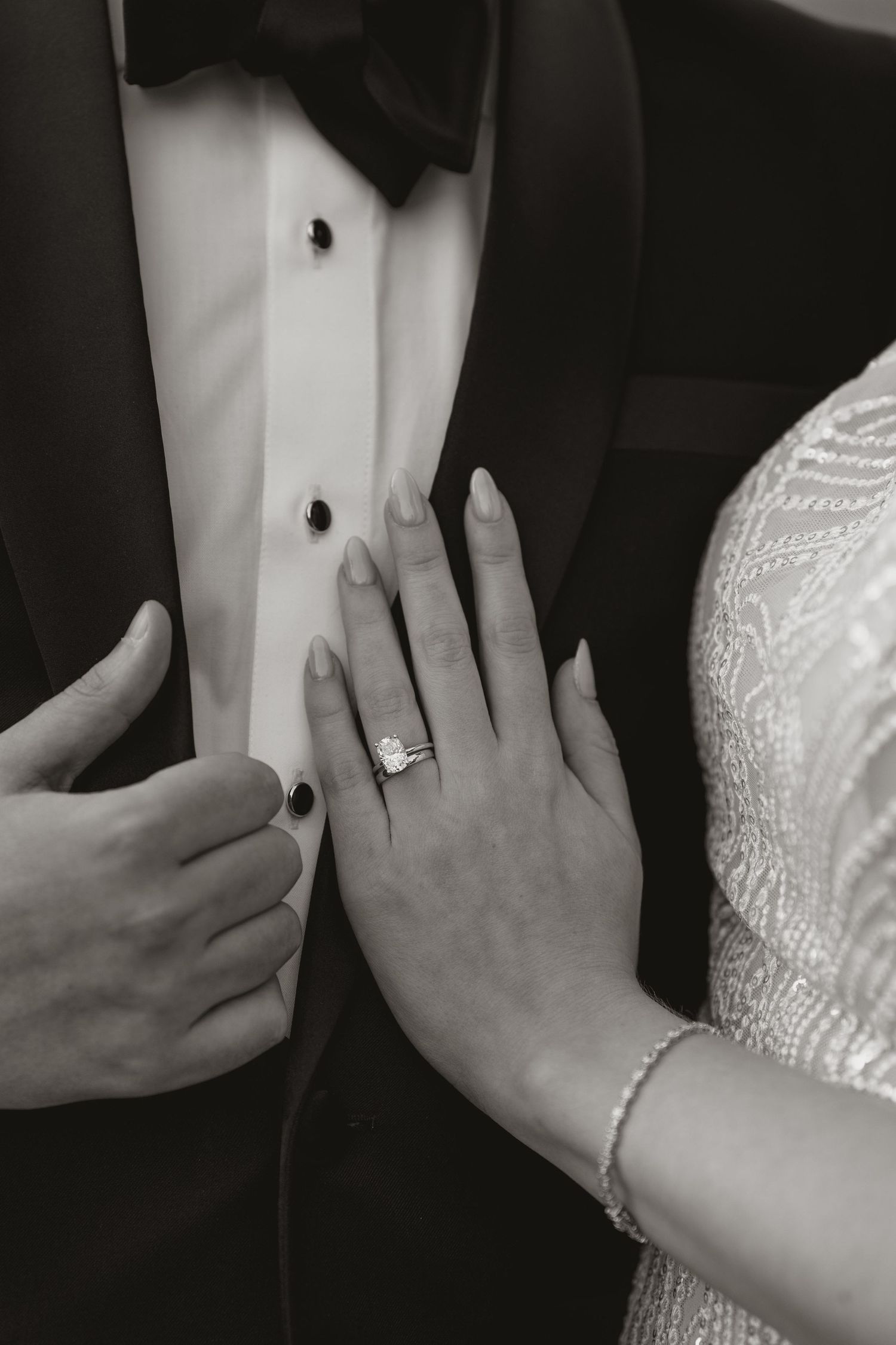 A series of wedding photos showing close-up shots of hands with rings and formal attire in black and white.