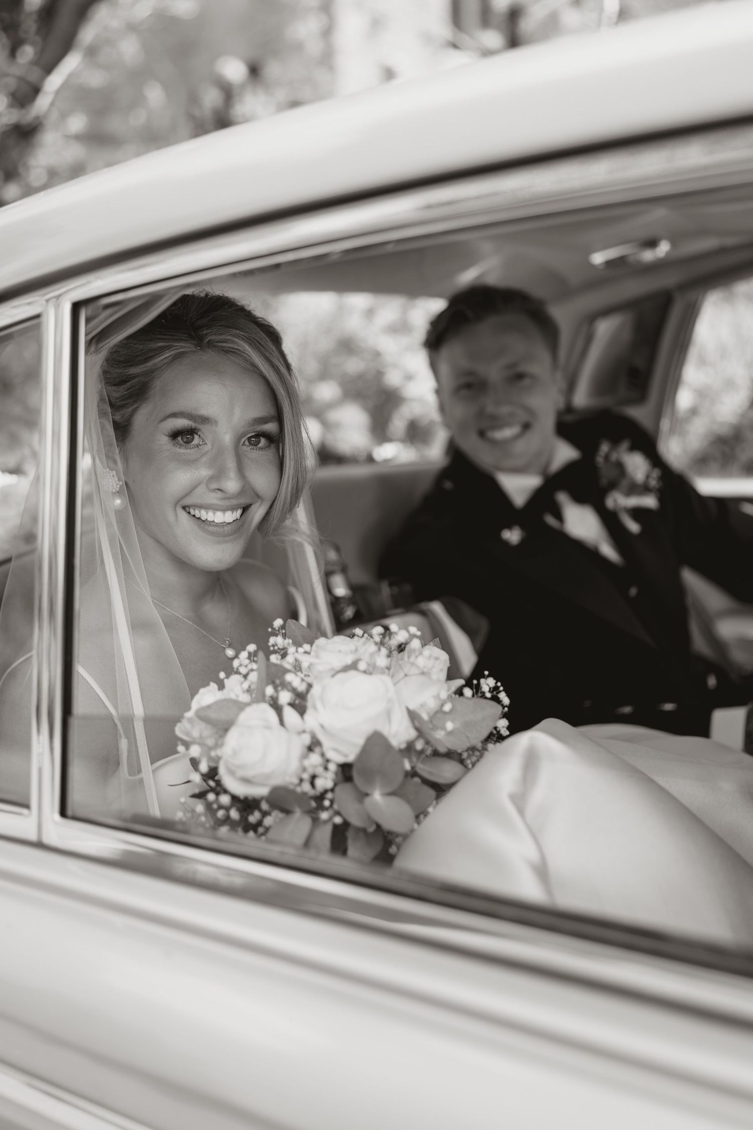 A sequence of black and white photos showing a bride in a car window on her wedding day.