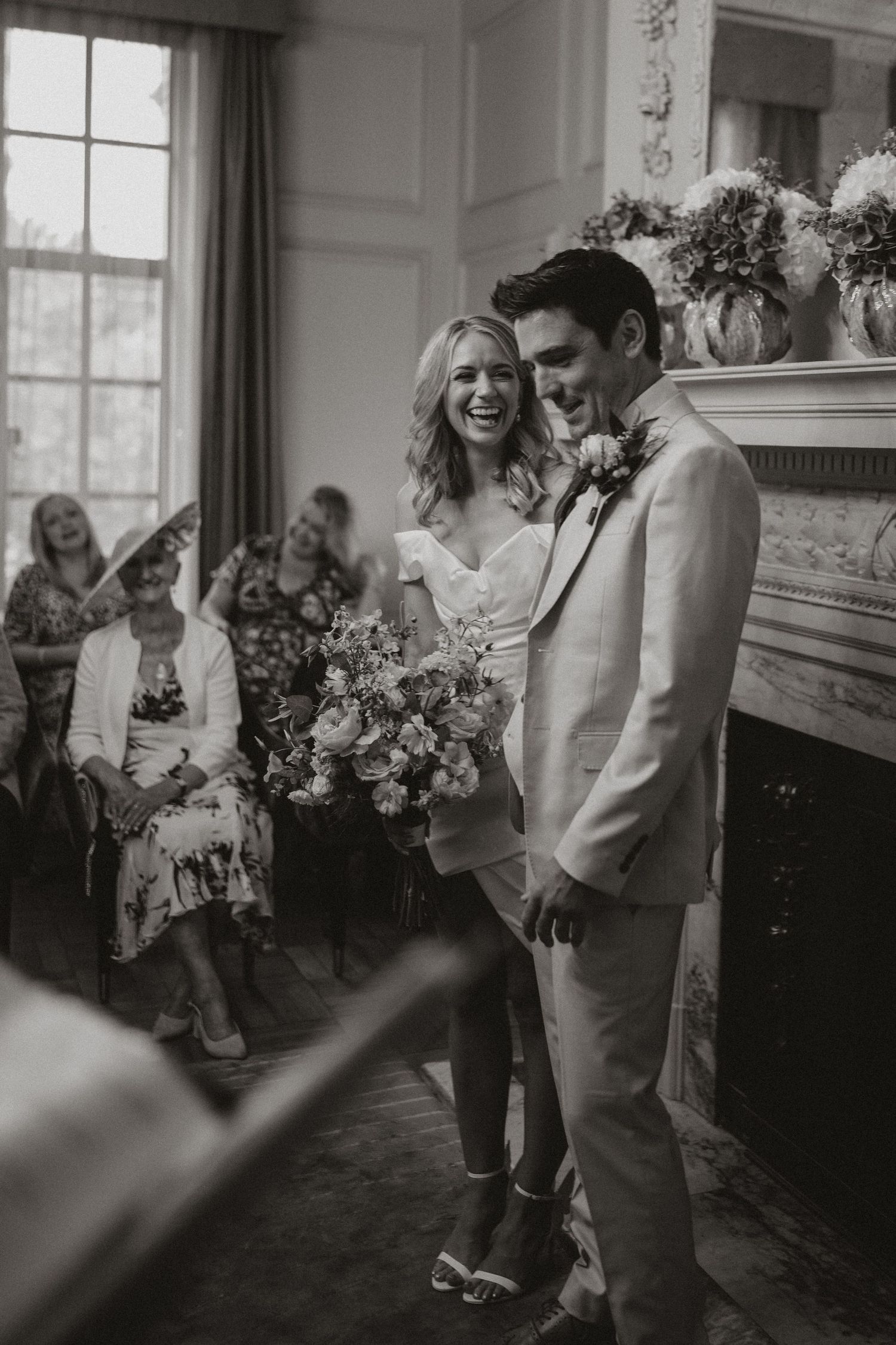 Black and white candid photos capture joyful moments at an indoor wedding celebration.