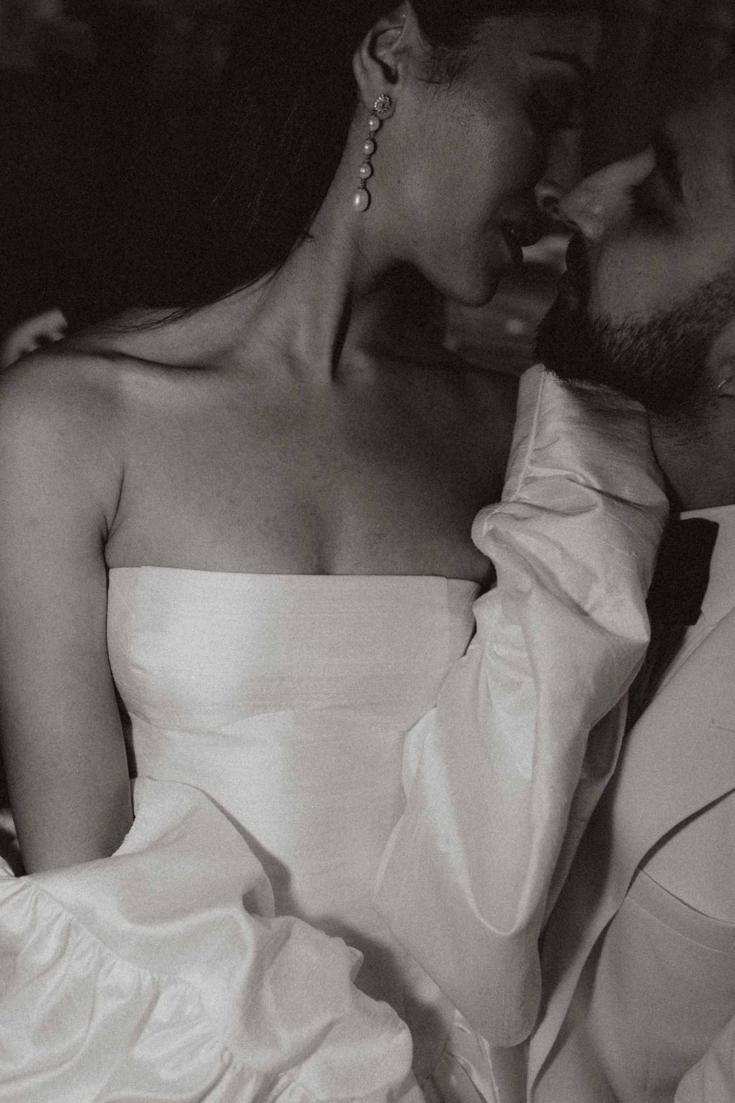A series of black and white images showing the upper portion of wedding dresses with strapless necklines.