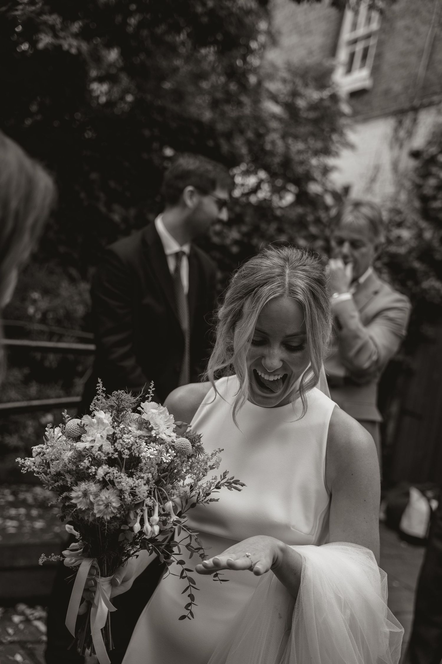 Black and white wedding photos showing bride holding bouquet and celebrating during outdoor ceremony.