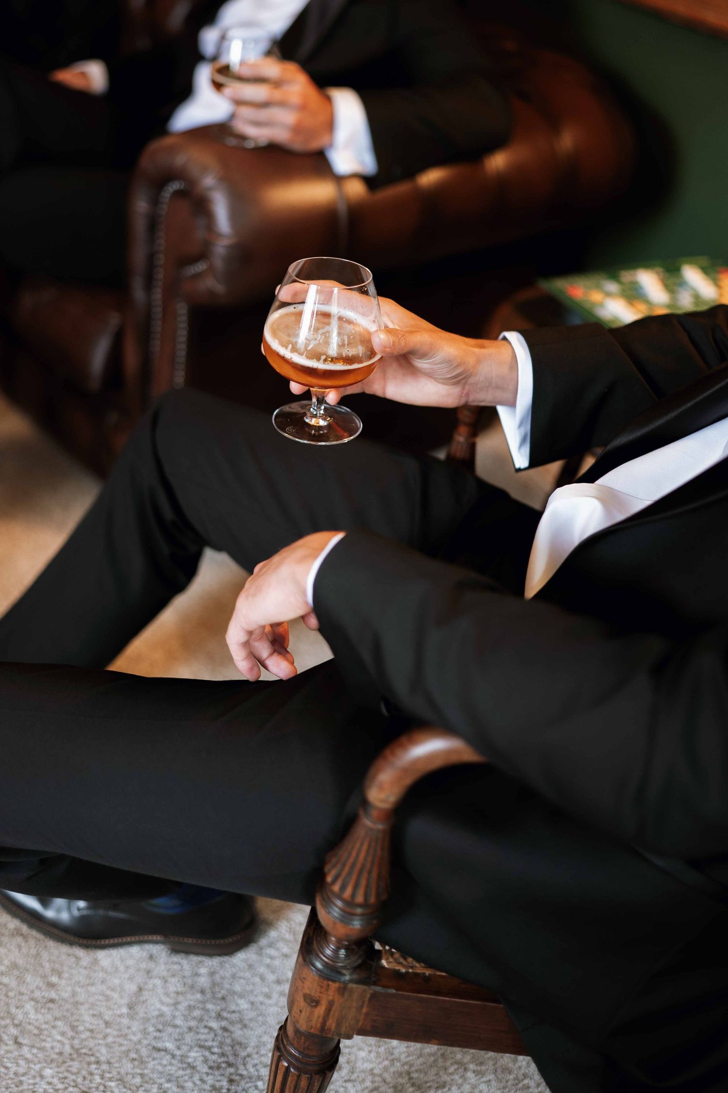 Close-up shots of hands pouring and serving drinks at an elegant cocktail bar.