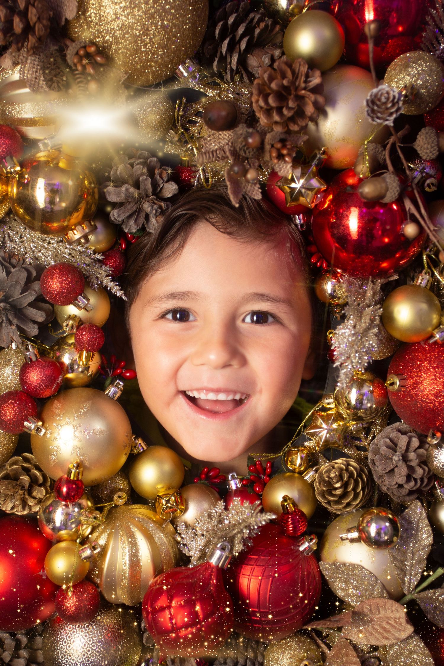 Festive Christmas wreath made of gold and red ornaments, pinecones, and glitter decorations creates a circular frame.