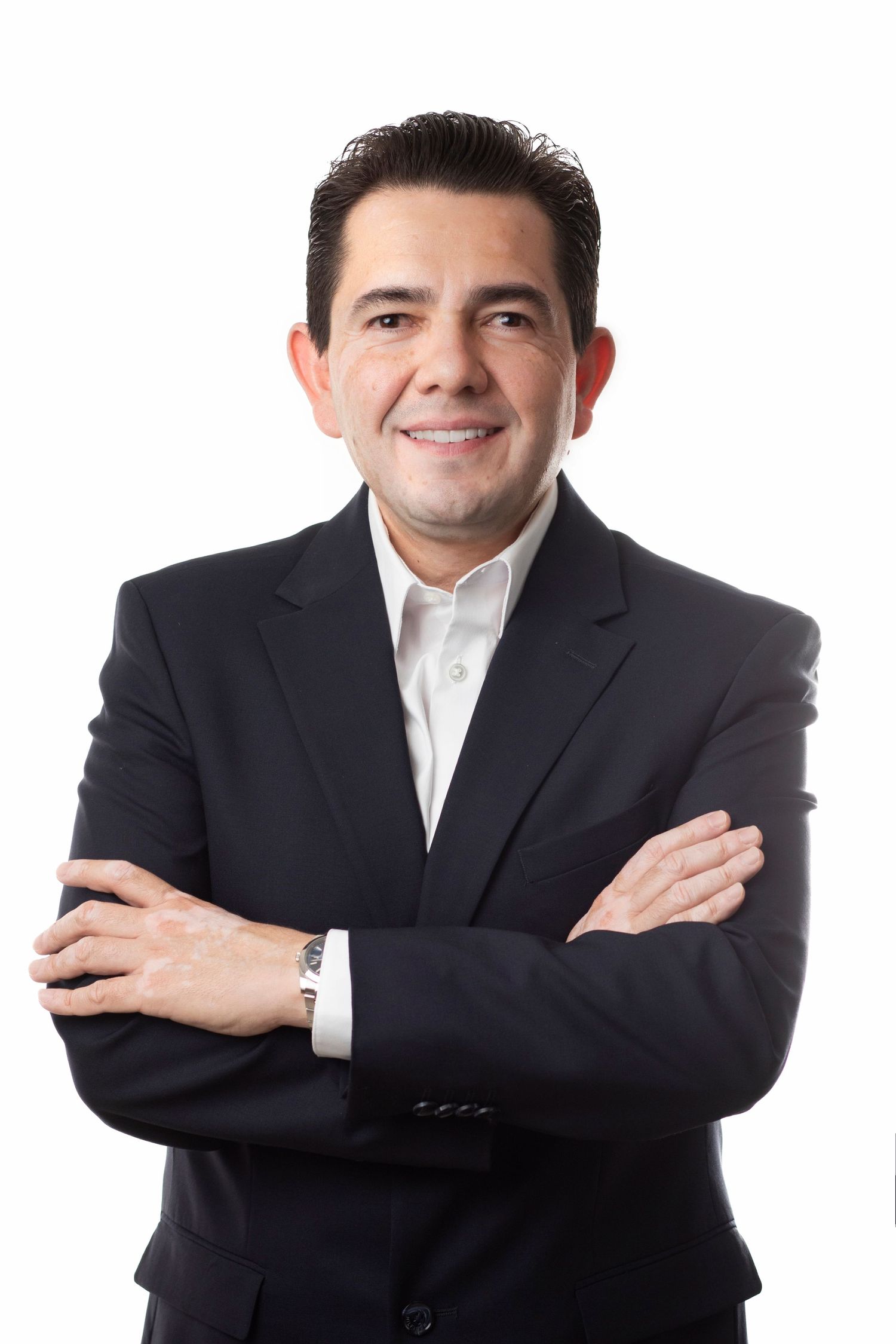Professional portrait series showing person in dark suit and white shirt posing with crossed arms against white background.