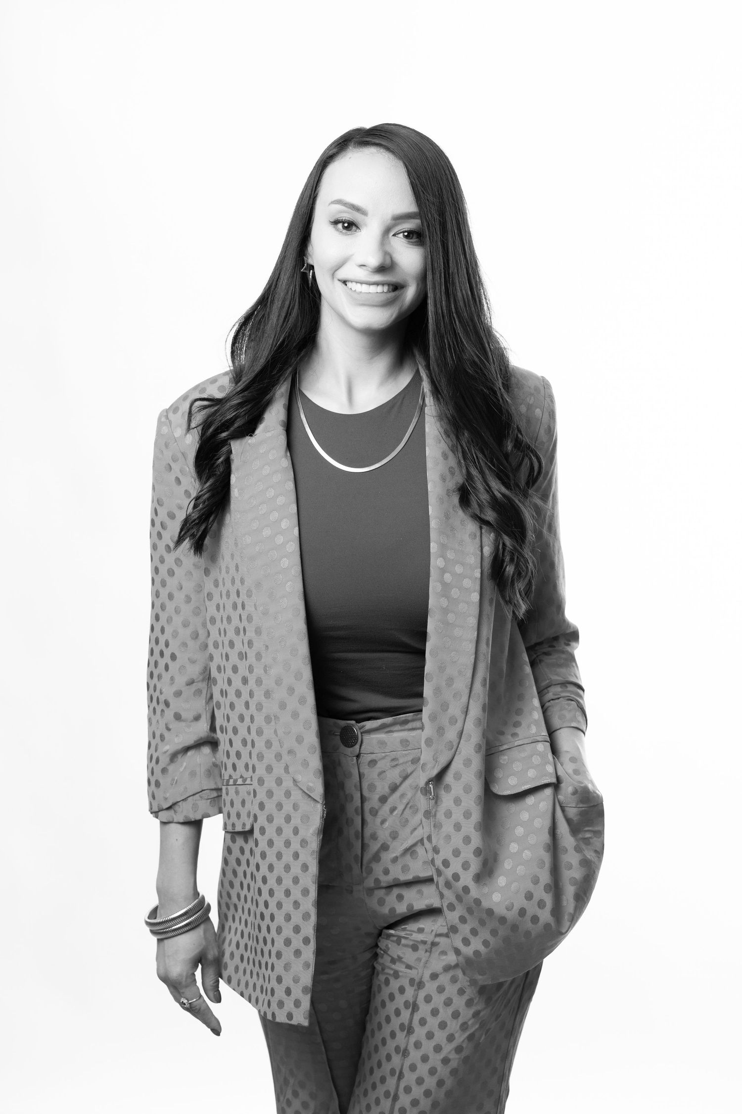 Professional portrait series showing a person in a polka dot blazer and dark top against a white background.