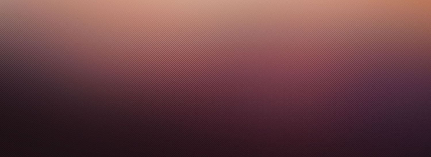A breathtaking sunset paints the sky in vibrant pink and orange hues reflecting off the calm ocean waters.