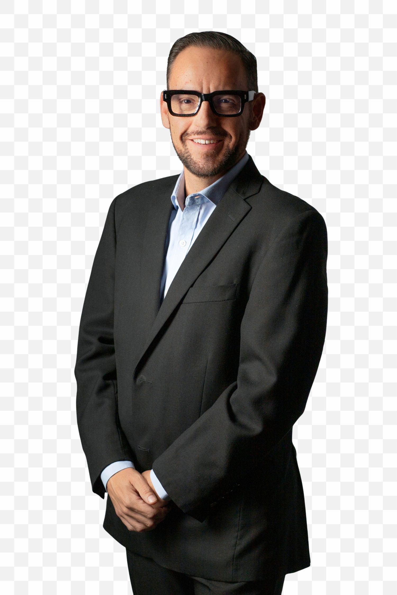Professional in black suit and glasses smiling while standing against transparent background.