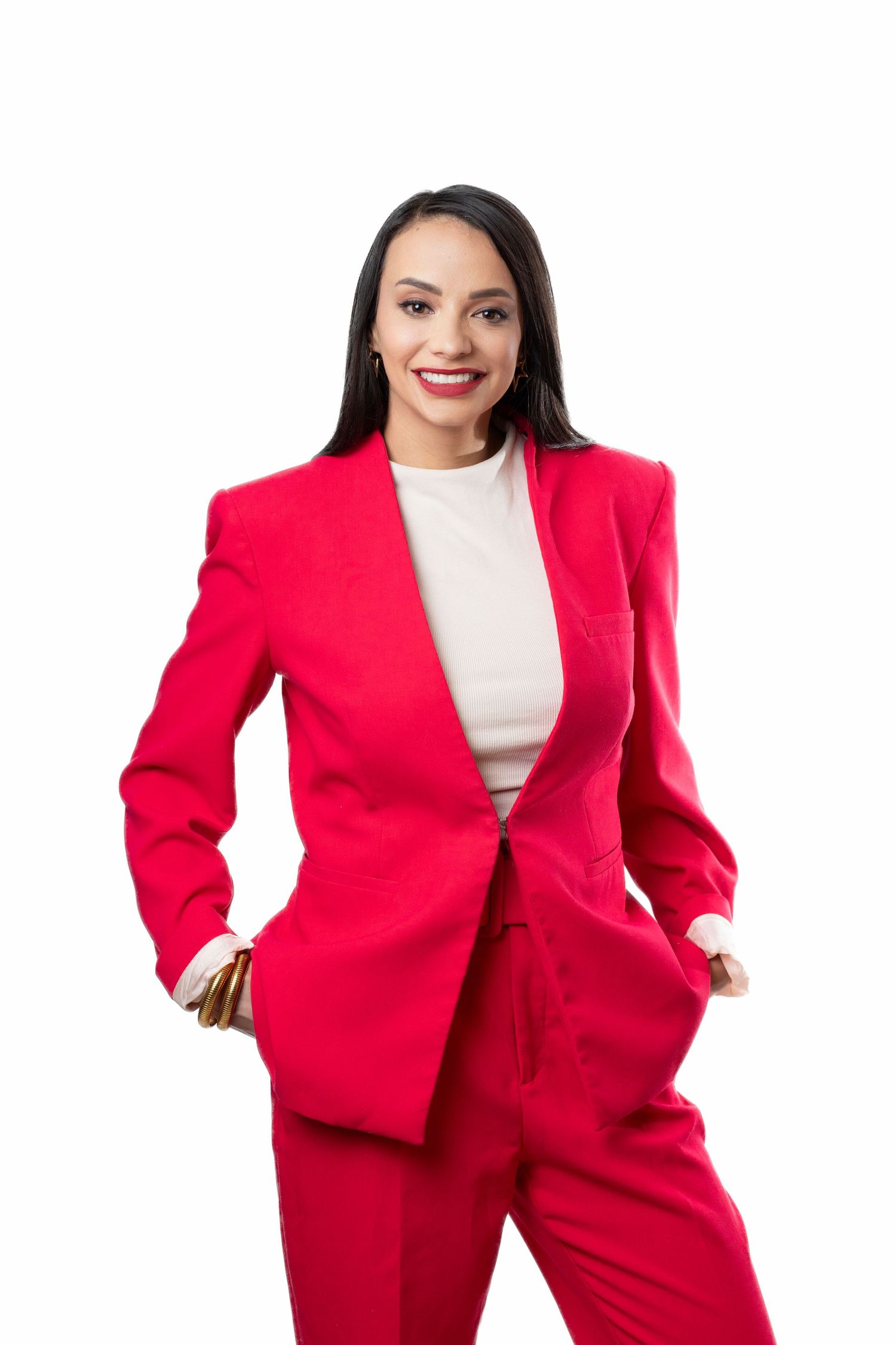 Professional model in vibrant red power suit and white top poses dynamically in multiple shots against white background.