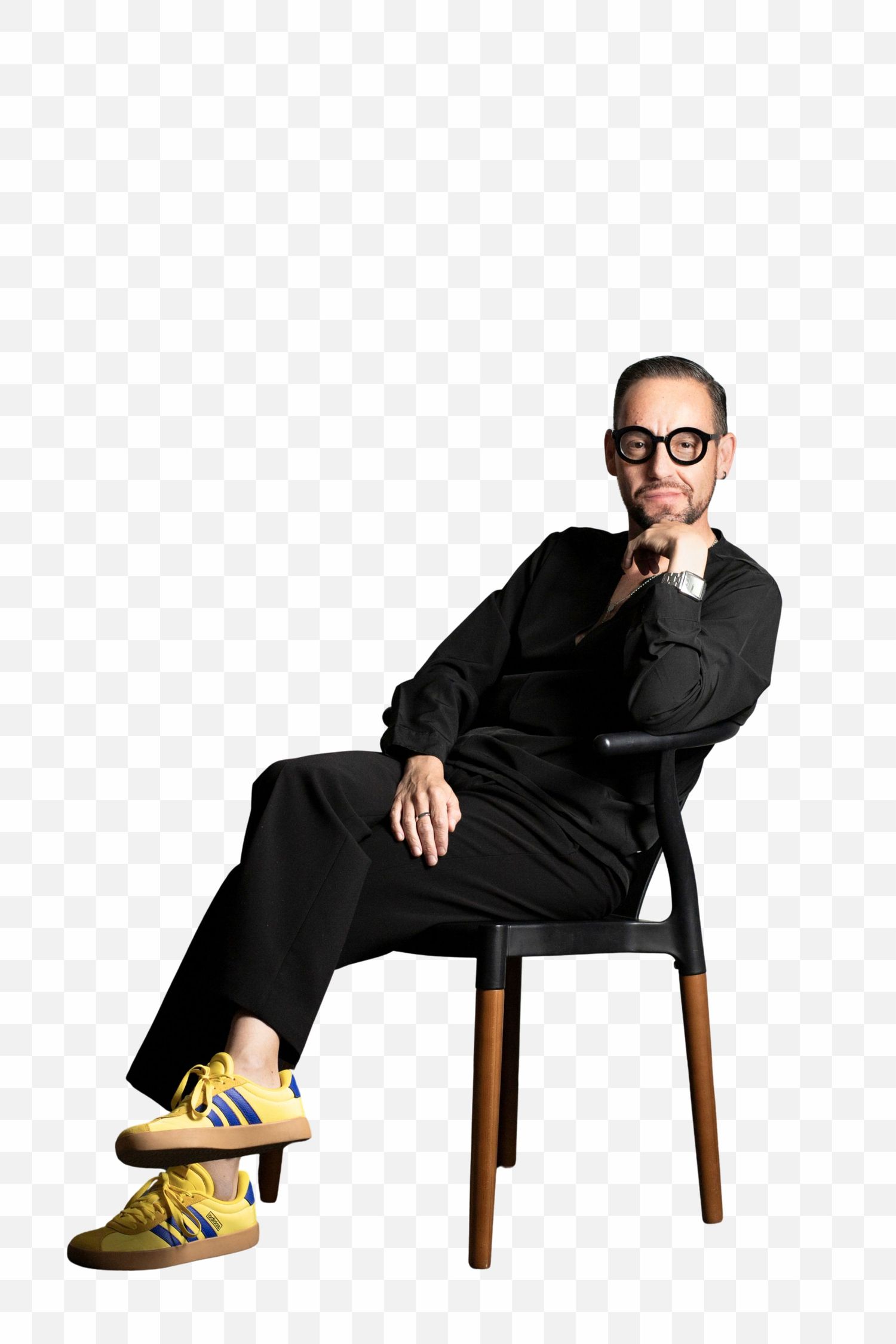 Person in black outfit and yellow shoes sitting on wooden chair in progressive falling motion sequence.