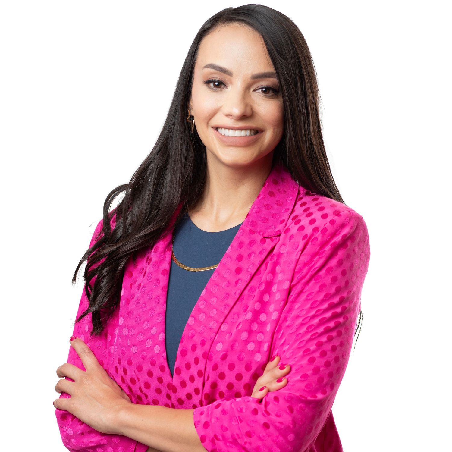 Professional portrait of someone in a bright pink textured blazer and navy top smiling warmly against white background.