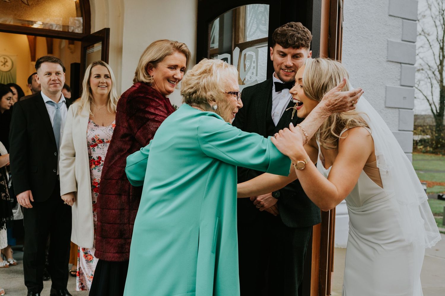 Wedding guest hugging bride at Drenagh Estate