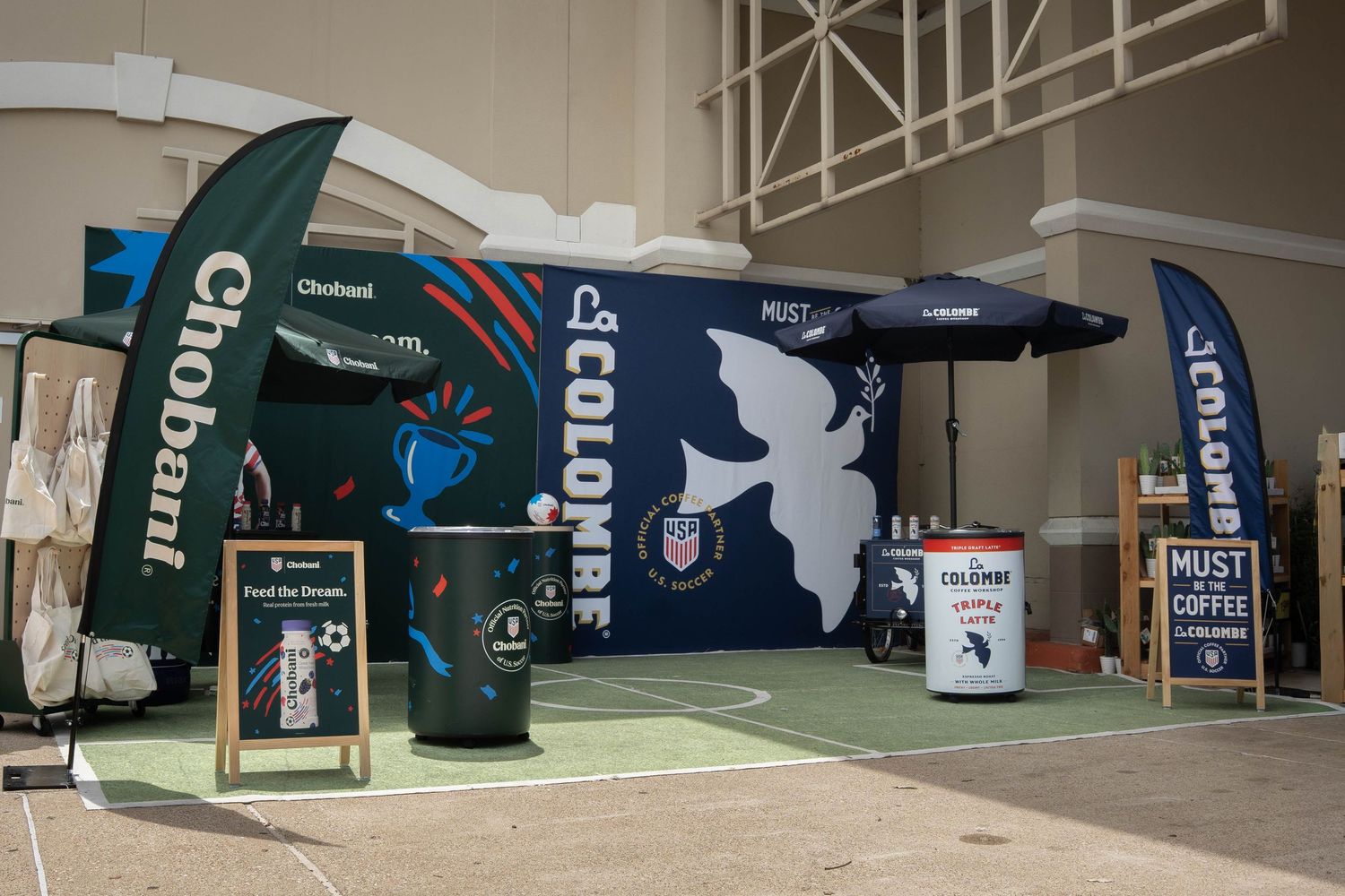 Chobani and La Colombe branded trade show booth display at an indoor expo event.