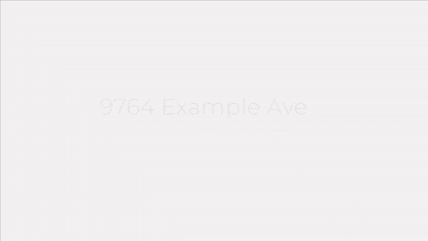 A white paper shopping bag with black handles and text sits isolated on a plain background.