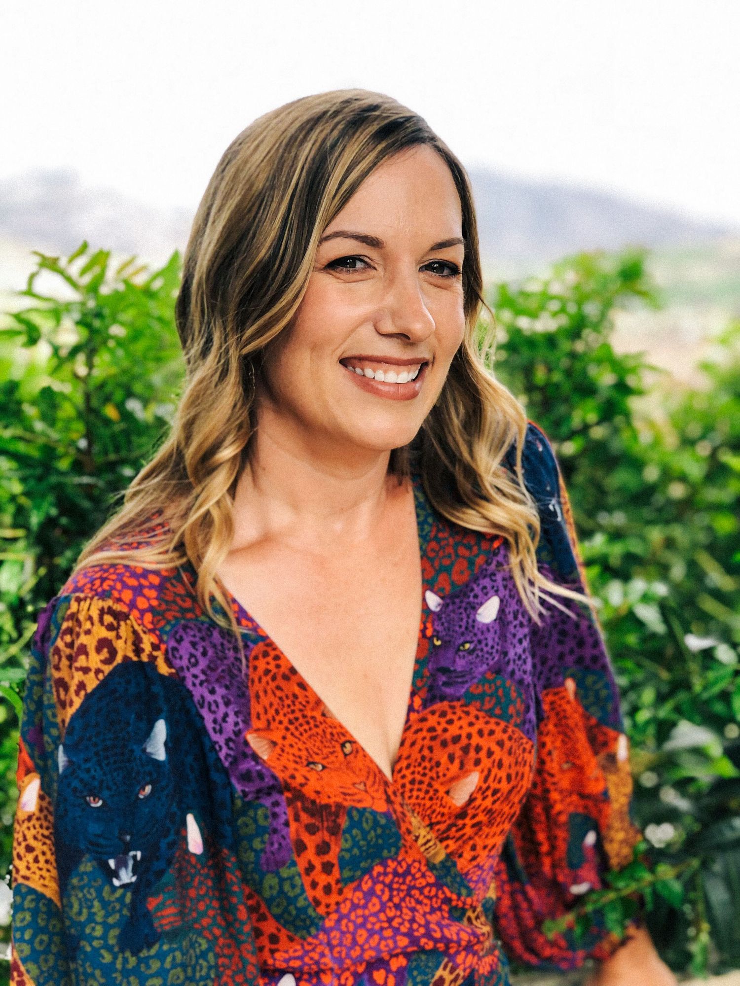 Portrait of Katie Gardner with bright colored shirt