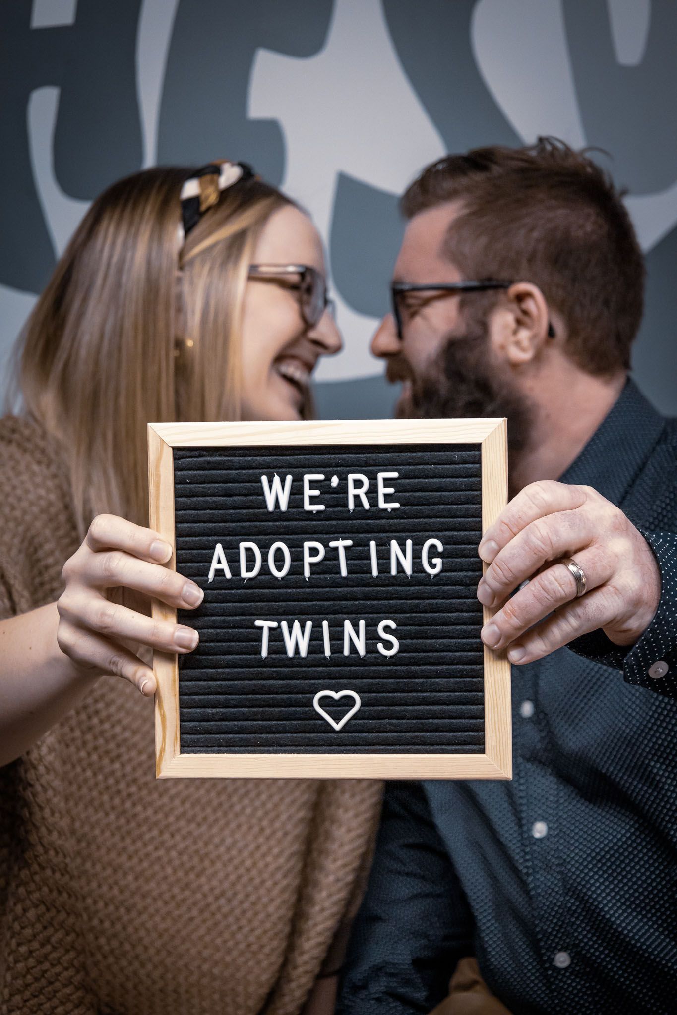 Couple holding a sign that says 