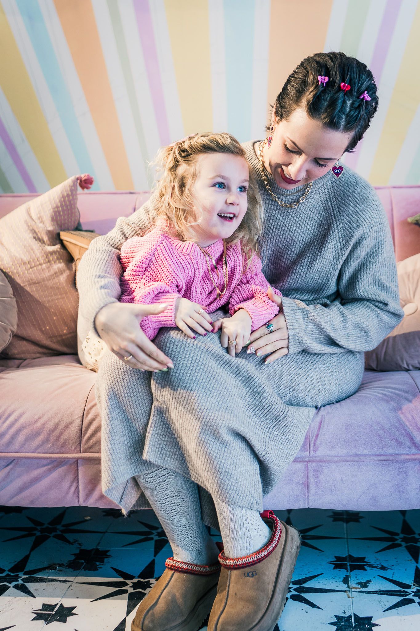 Mom and daughter hugging on a couch