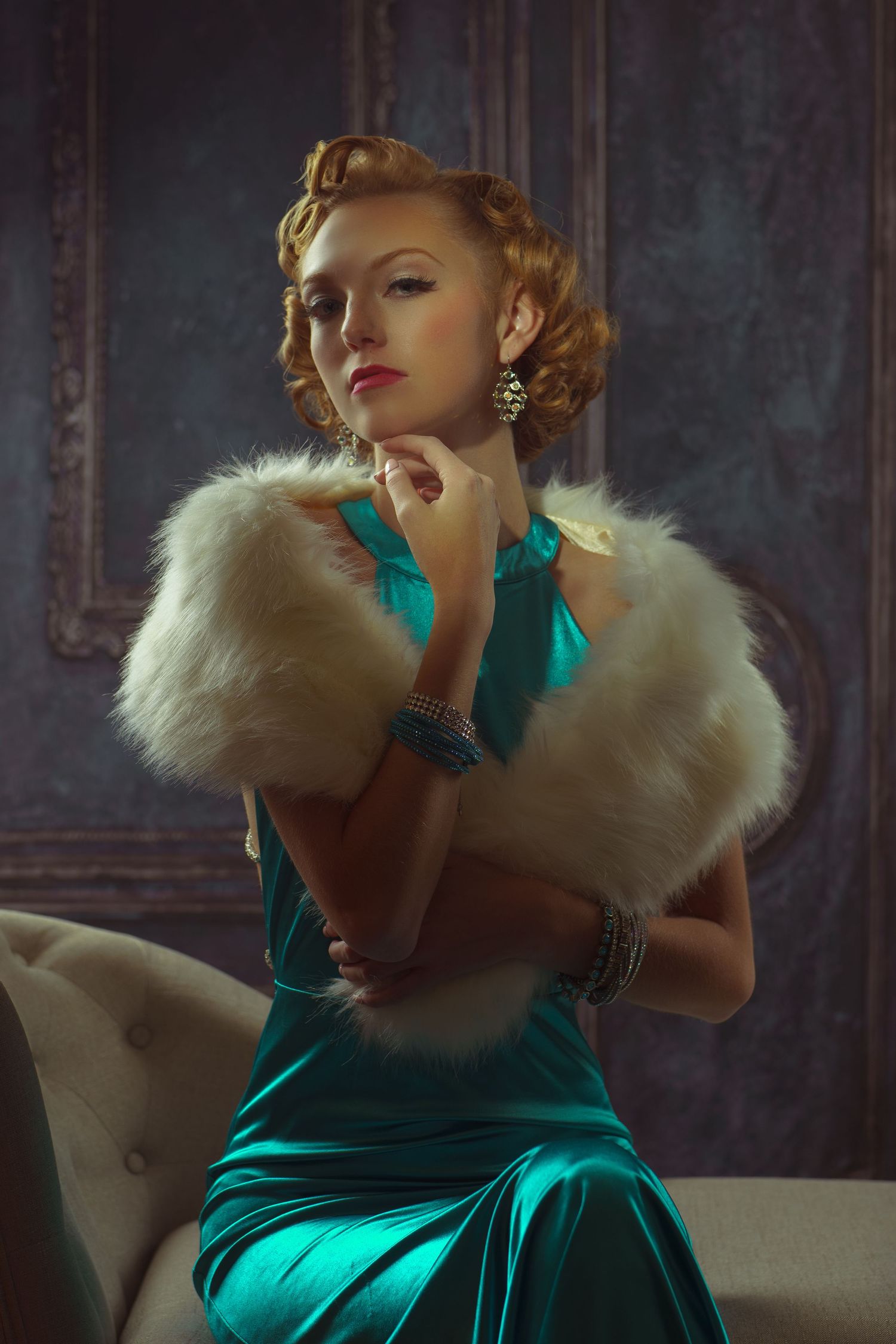 Glamorous vintage-style portrait featuring emerald green velvet dress with white fur collar in moody lighting.