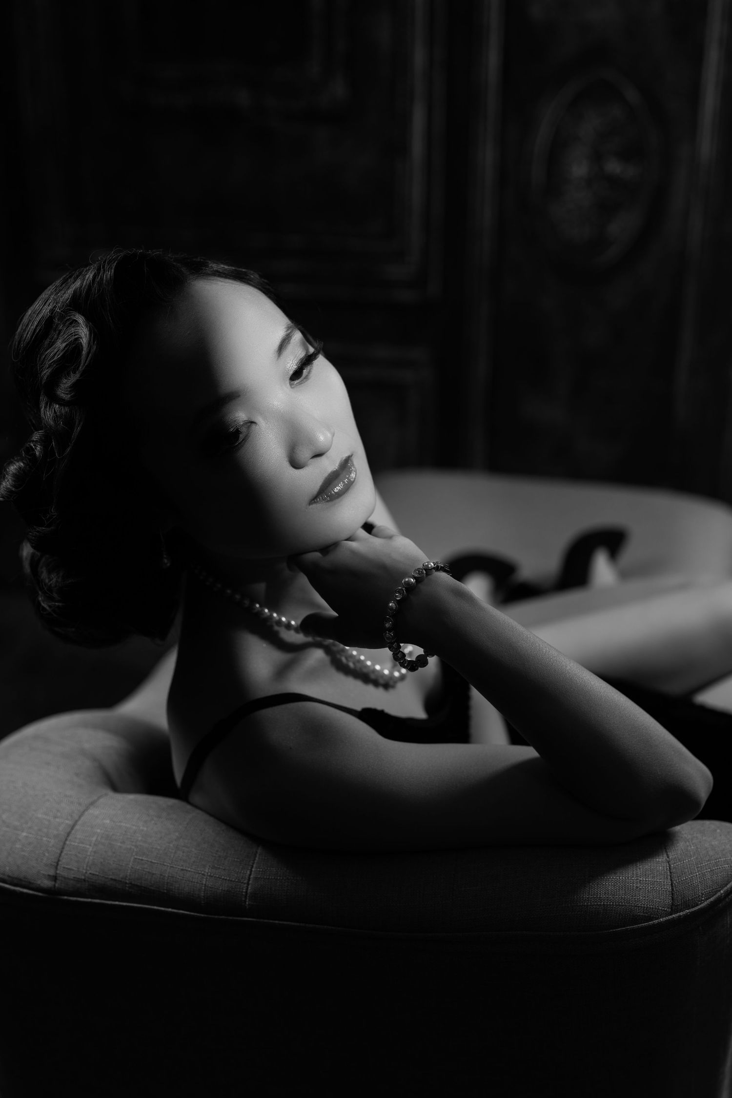 Artistic black and white boudoir portraits with dramatic shadows.