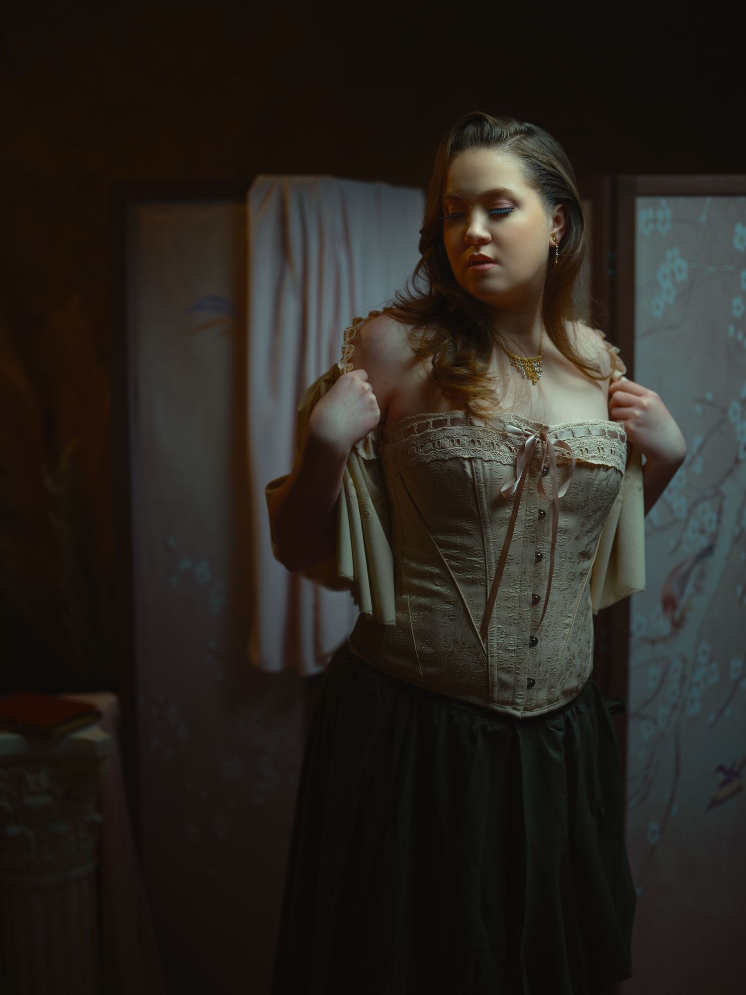 Figure in Victorian-style beige corset and dark skirt posed against curtained background.
