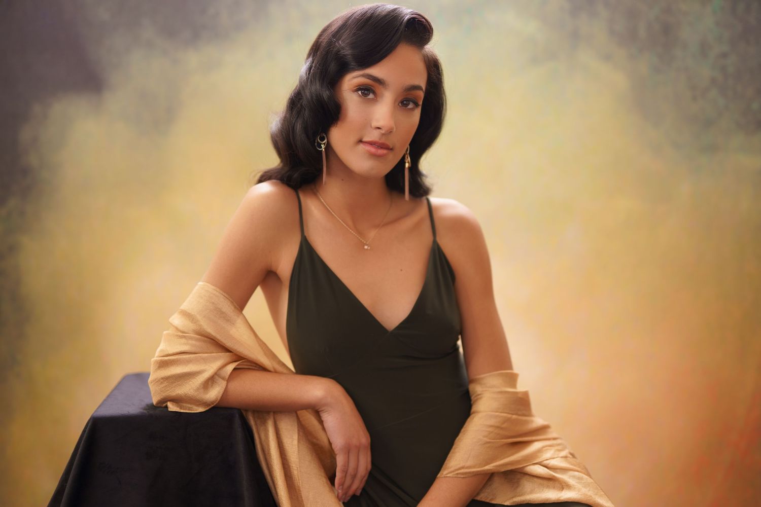 Studio portrait series with warm lighting and contrasting black and tan wardrobe.