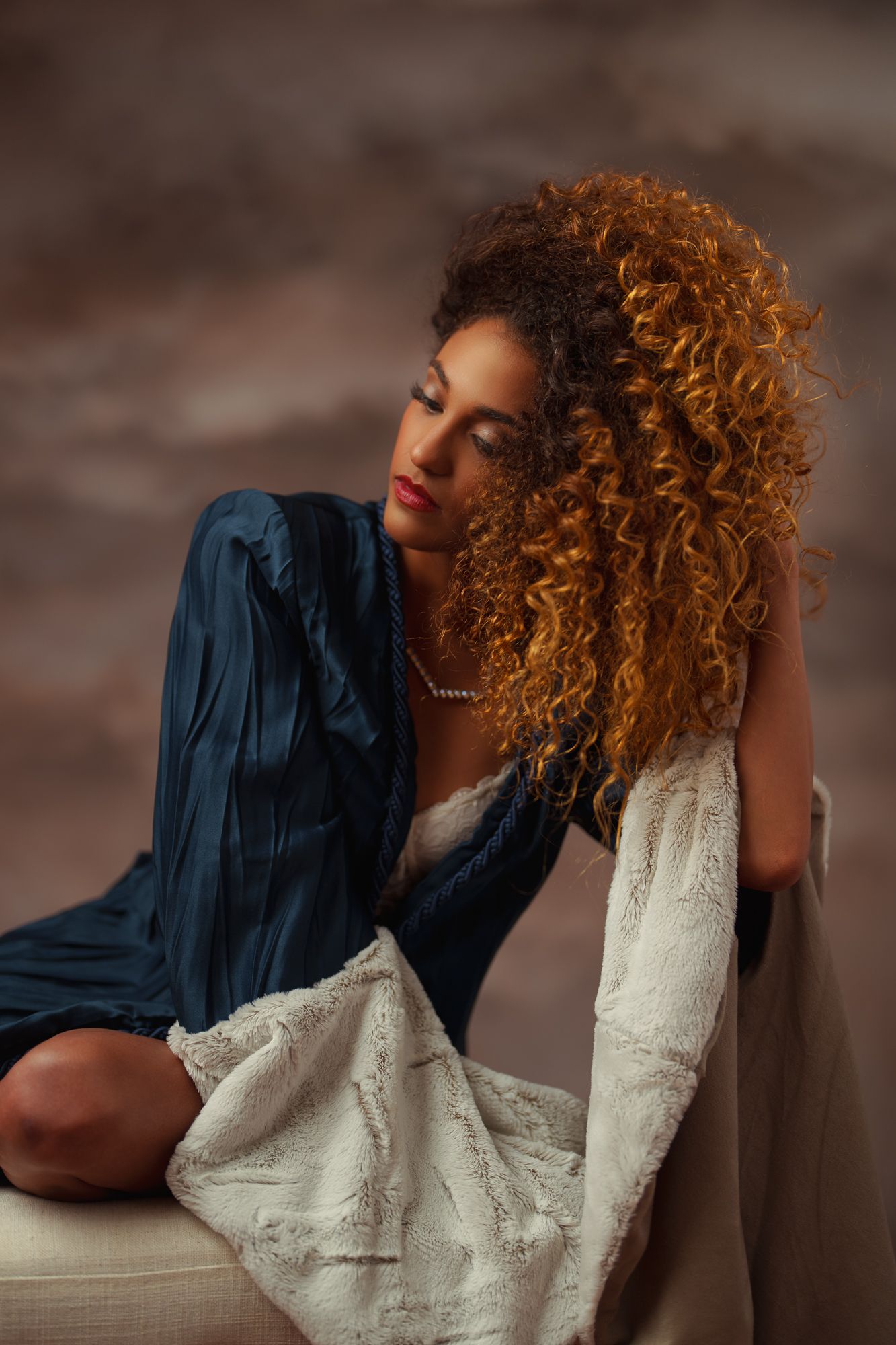 Moody fashion series featuring curly hair and contrasting navy and cream colored garments.