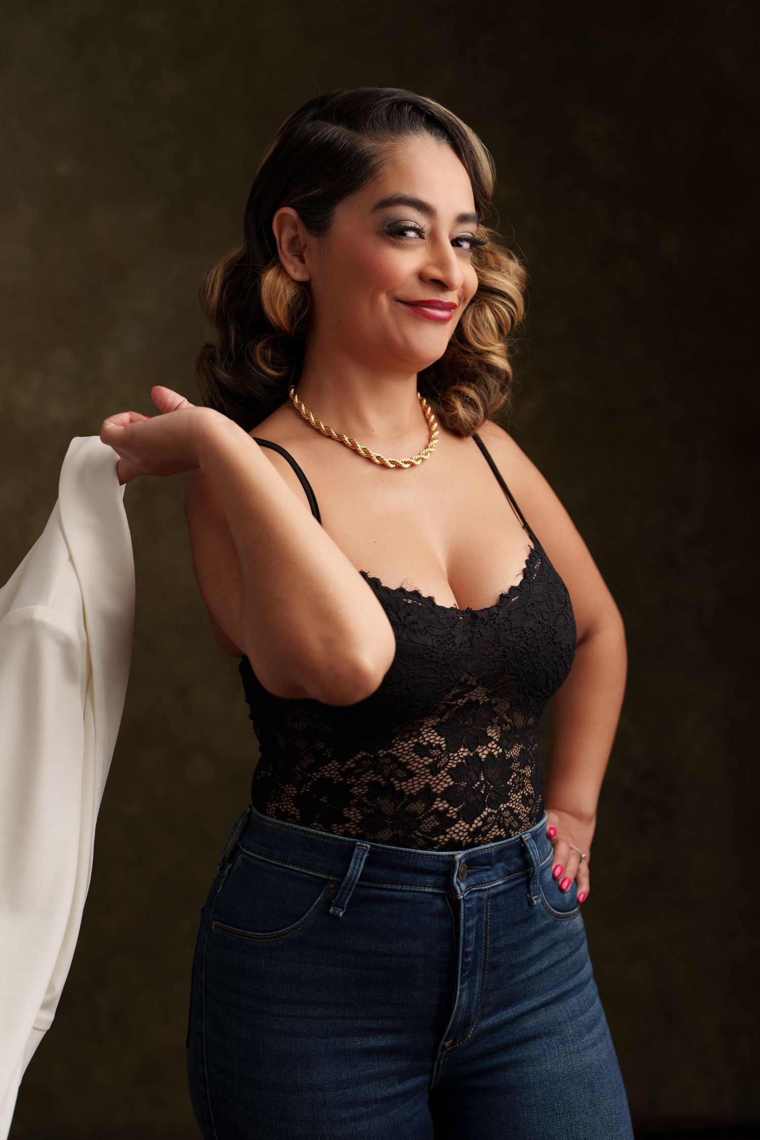 Portrait series in black lace camisole and denim against dark backdrop.
