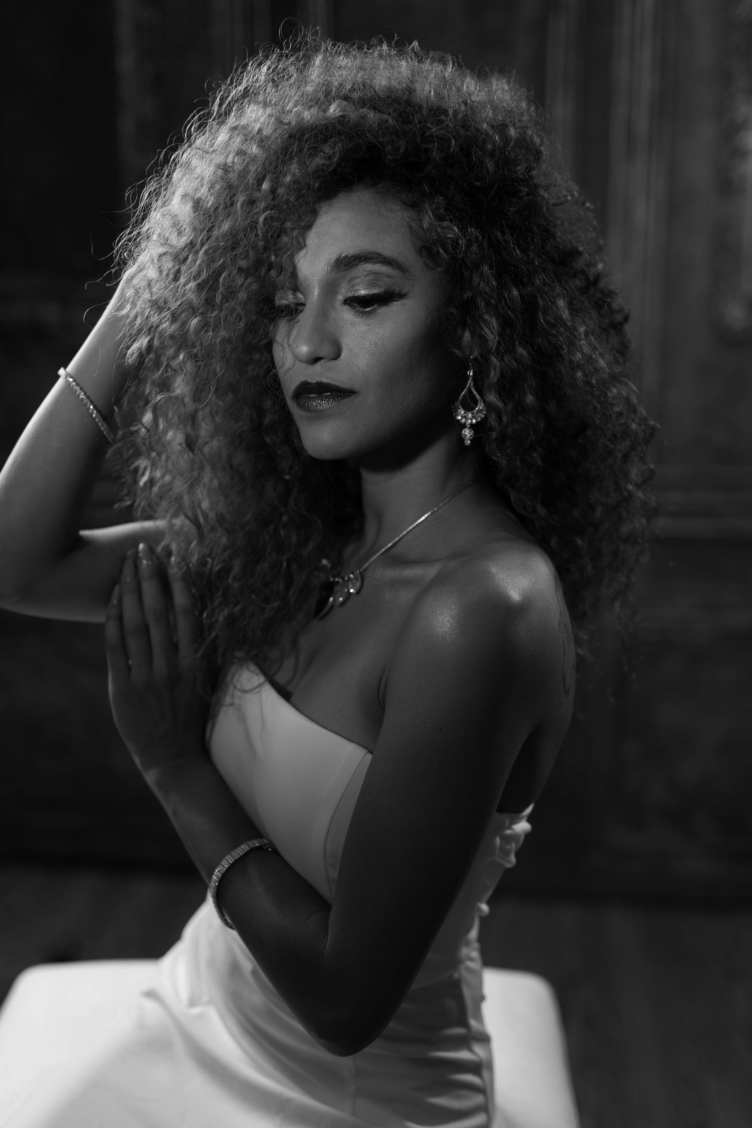 Artistic black and white portraits featuring dramatic curls and elegant poses in noir style.