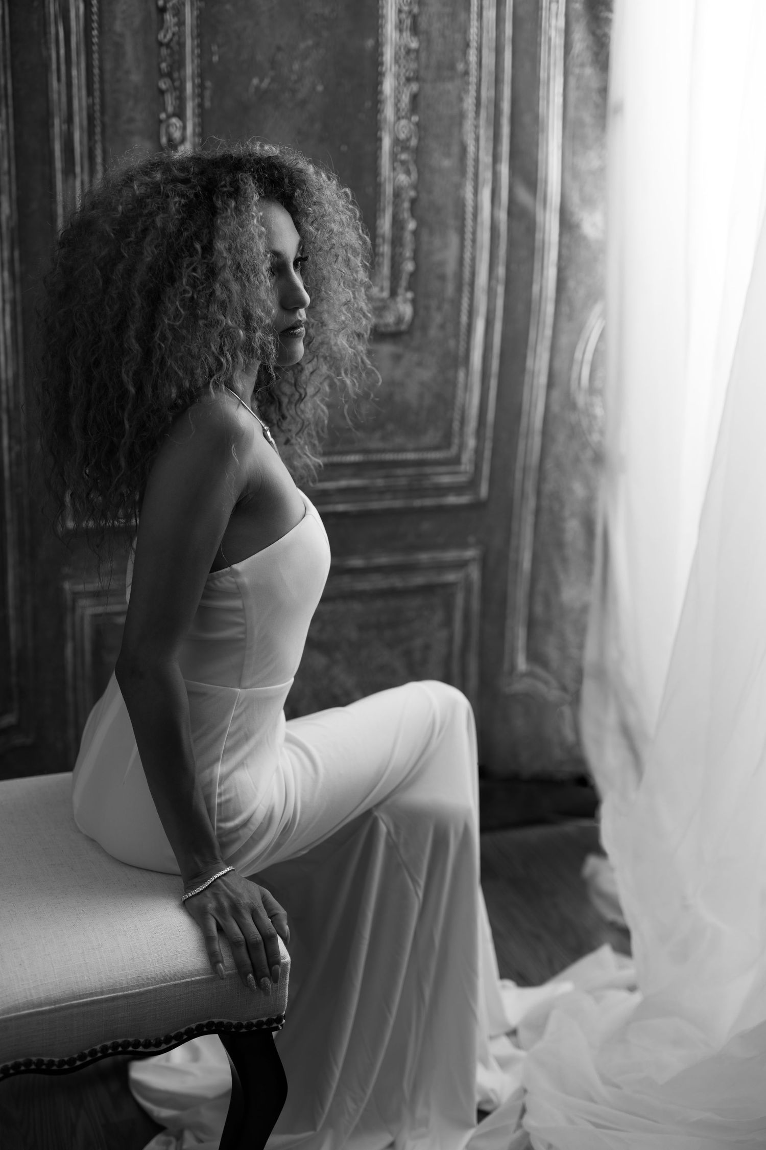 Ethereal portraits featuring white dress against textured vintage backdrop.