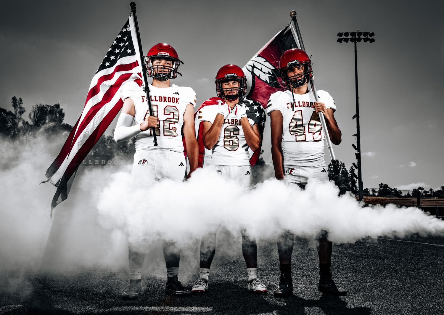 A dramatic black and white sports photo collage featuring football players with an American flag and smoke effects.