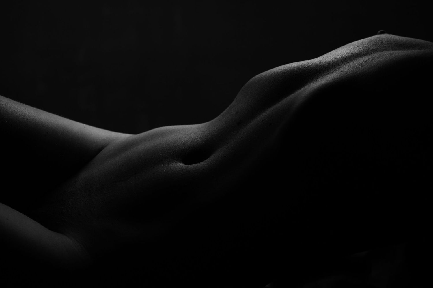Abstract bodyscape photography highlighting natural curves in monochrome.