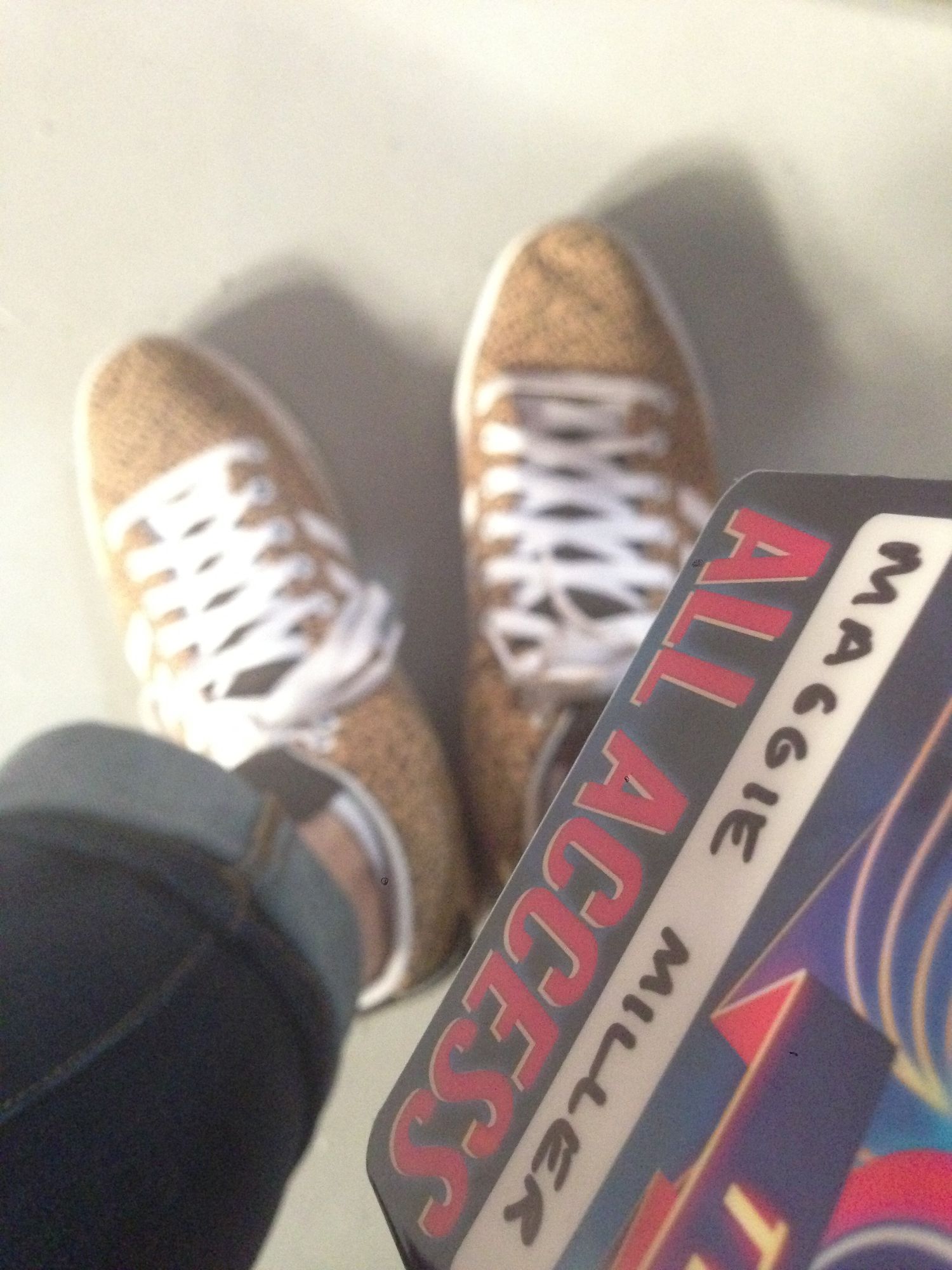 Closeup detail shot of an athletic shoe with red and blue branding details.