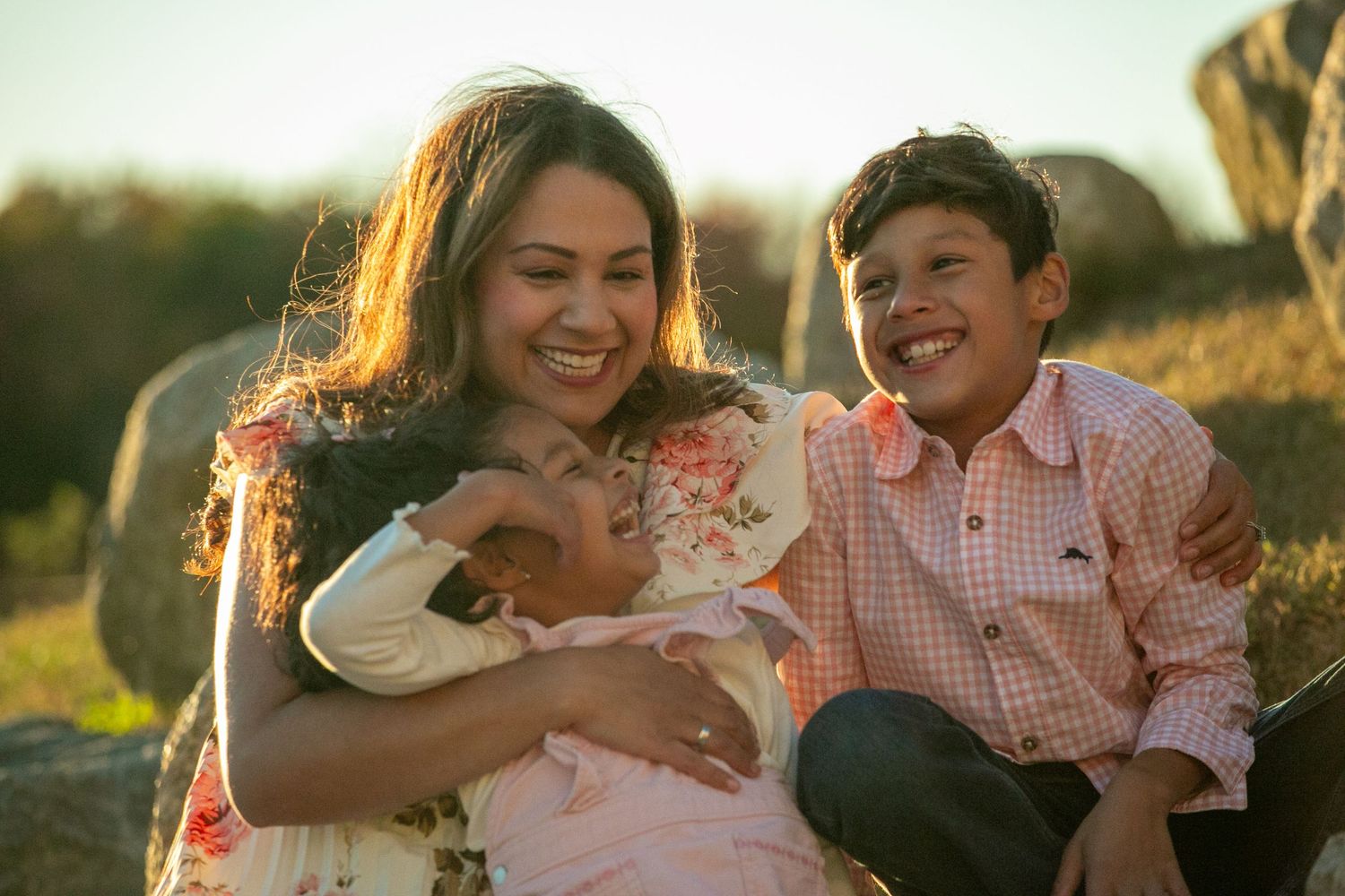 A couple shares tender moments together in a golden sunlit field during a romantic outdoor photoshoot.