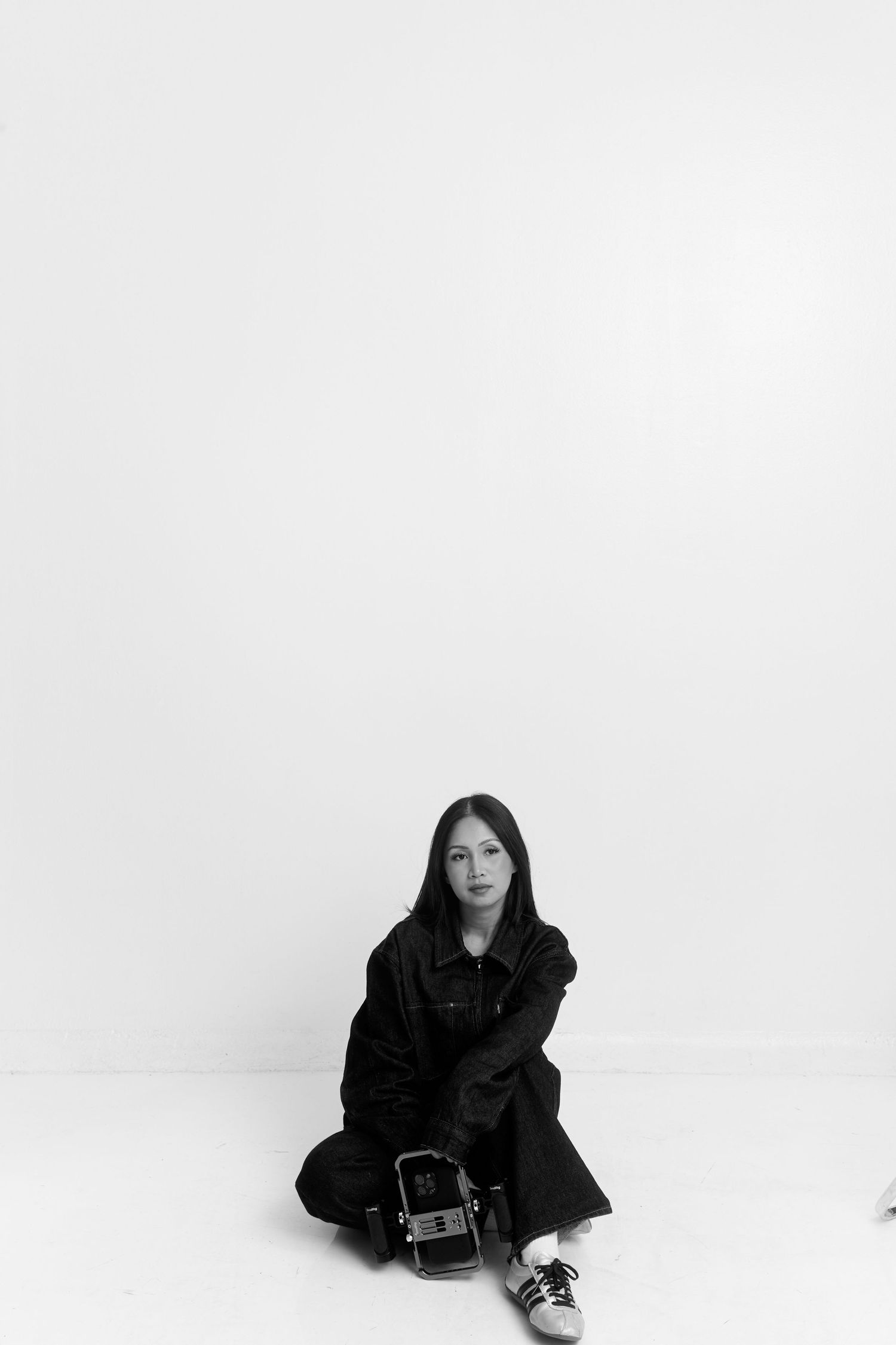 Black and white portraits showing different seated poses against stark white background.