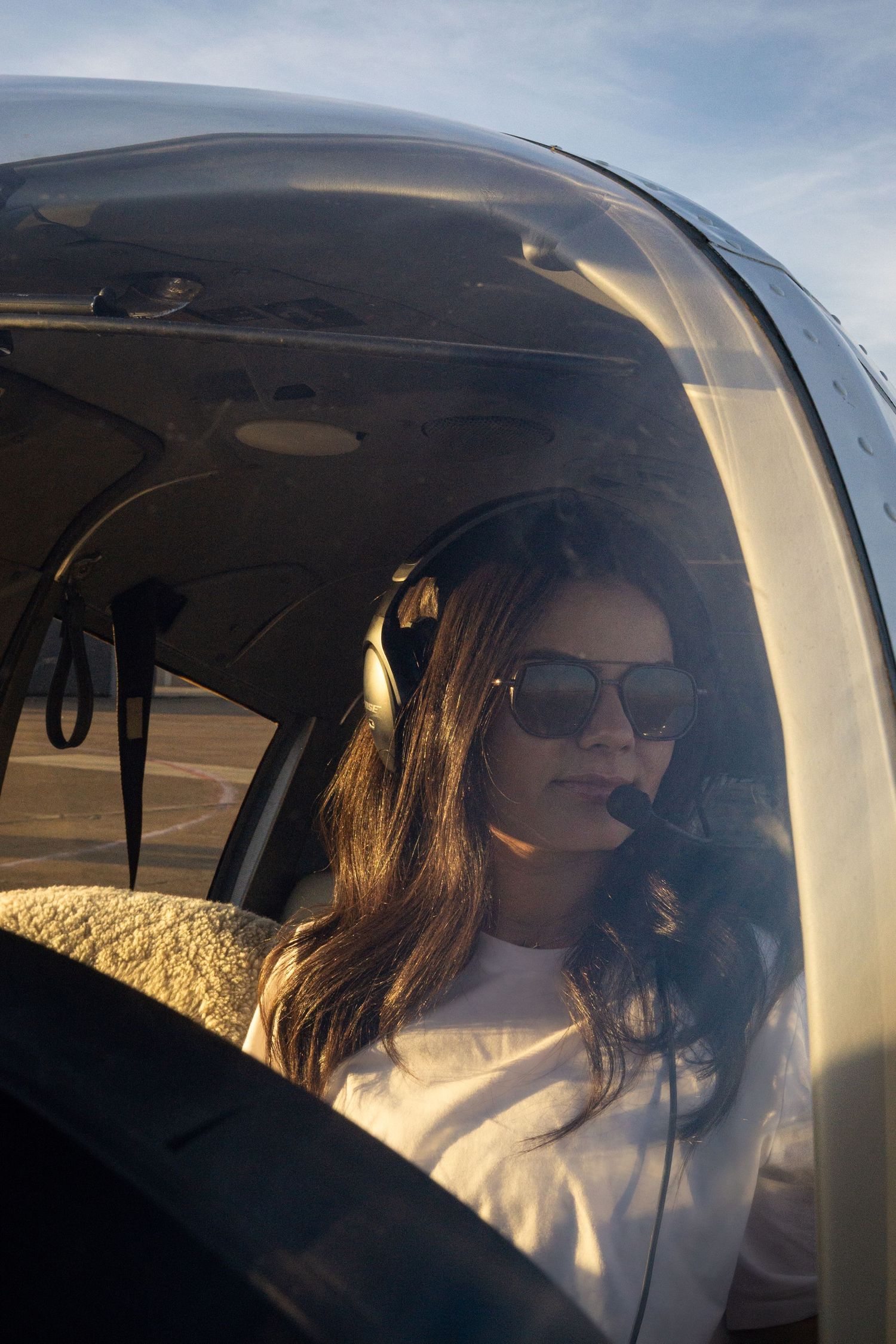A sequence of photos showing someone in sunglasses sitting in the cockpit of a small aircraft during golden hour.